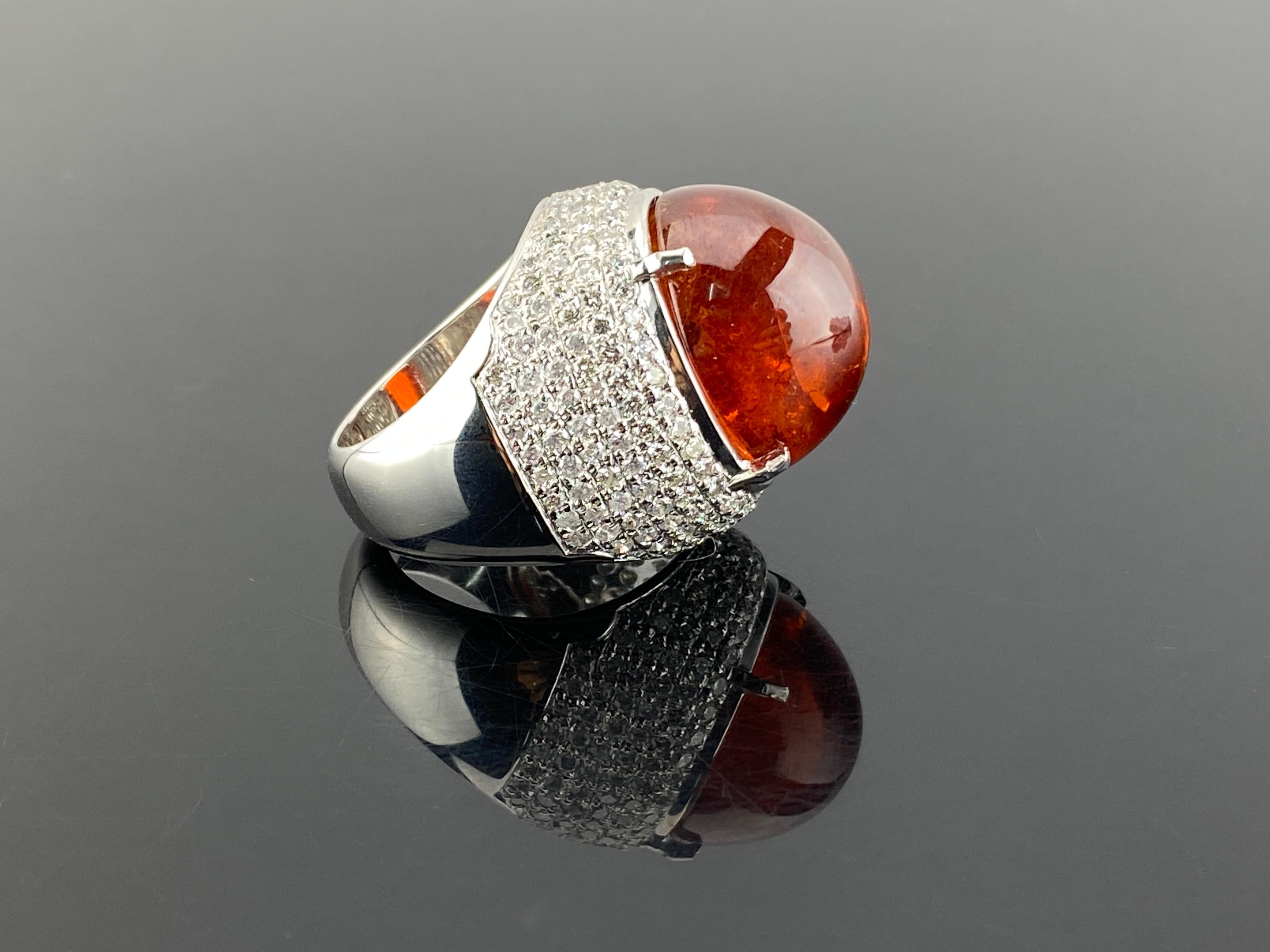For a look that is regal and refined, look no further than this impressive 52.86 carat Mandarin Garnet cabochon ring. This spectacular gemstone is a statement of true luxury and exquisite taste. The color of a perfect Mandarin orange (hence its
