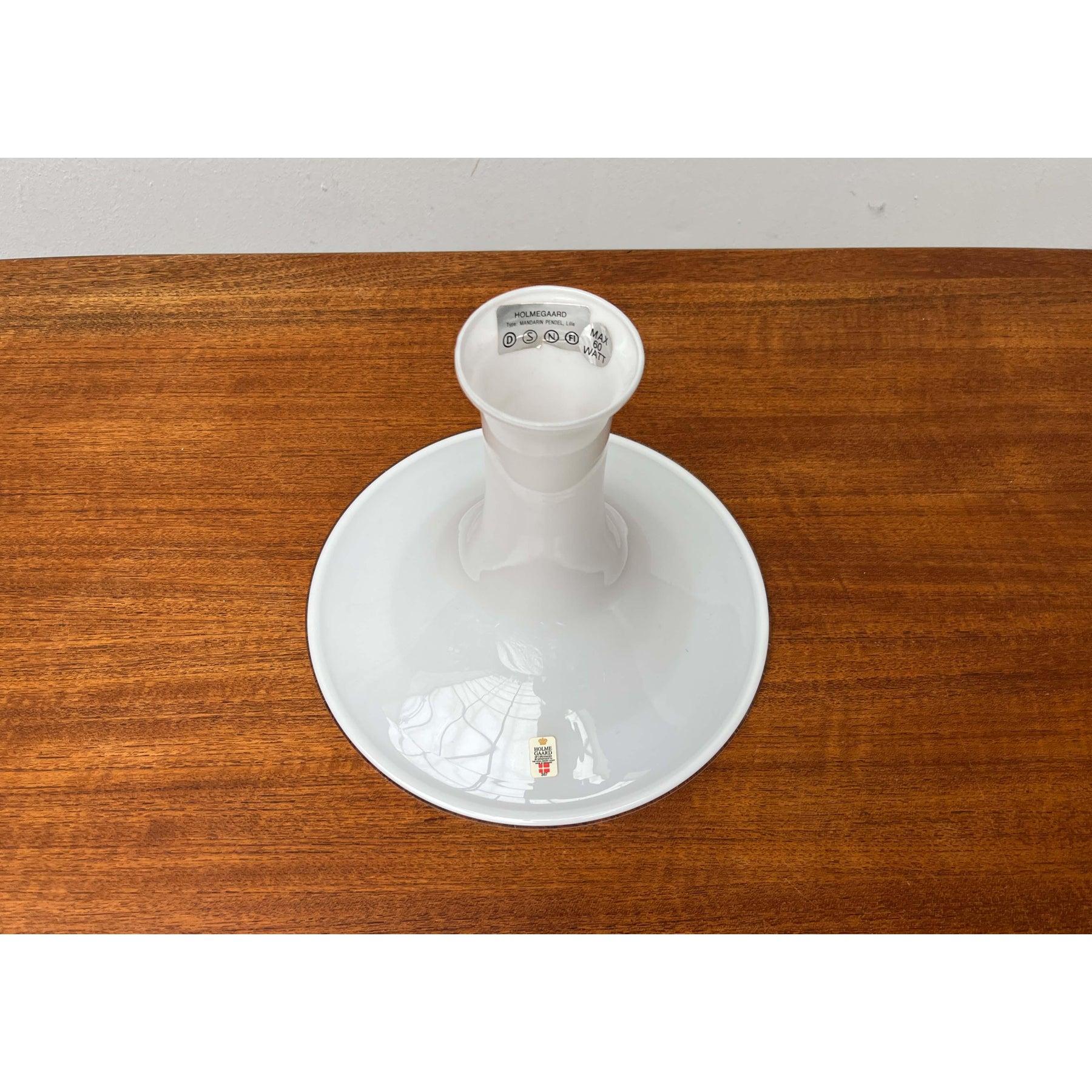 Elegant glass pendant lamp from the Danish manufacturer Holmegaard based on a design by Michael Bang from the 70s. Here only the shade as a replacement without a frame element.
A design in traditional design language. This pendant light impresses
