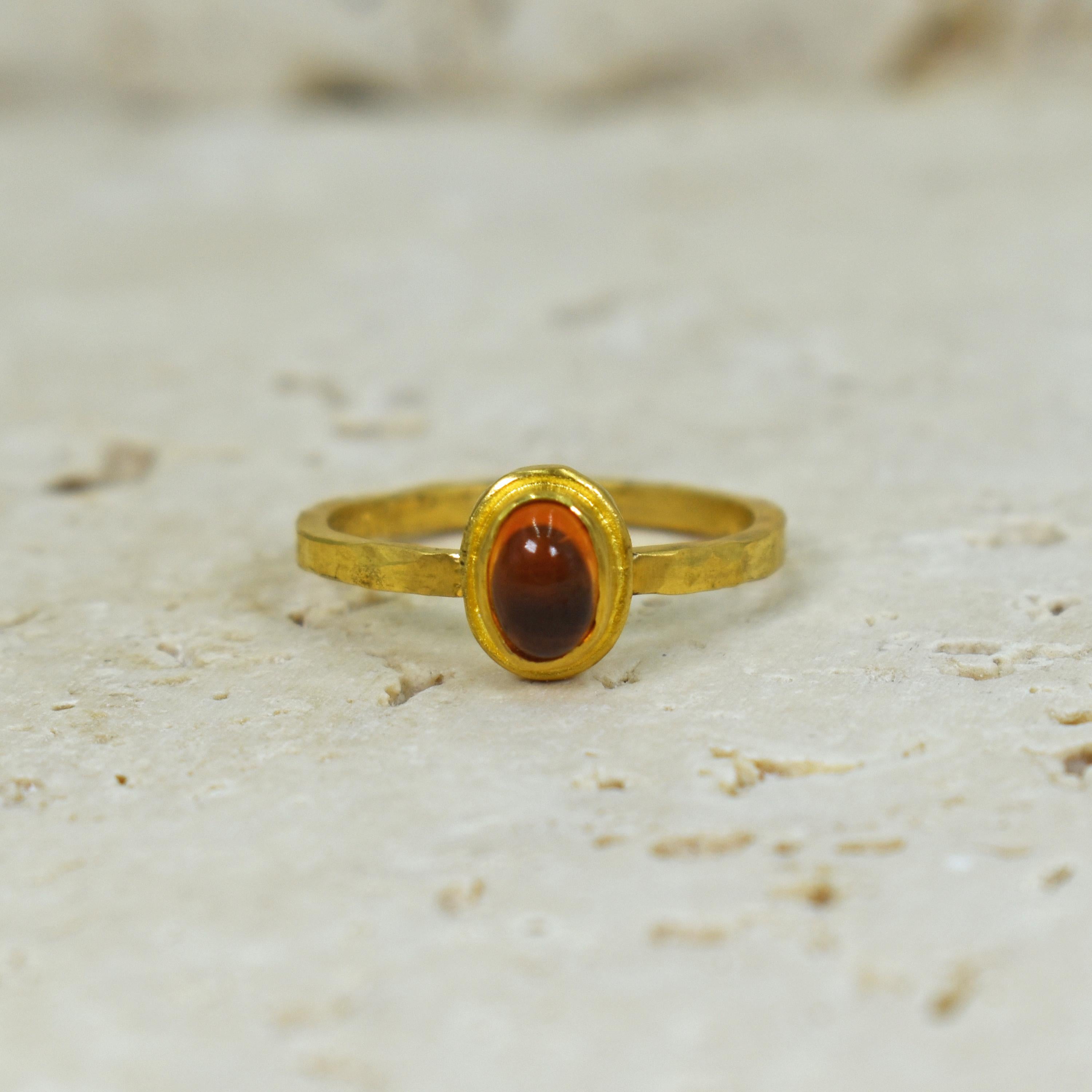 Mandarin Spessartite Garnet one carat cabochon set in a textured, hand forged 22k yellow gold solitaire ring. The warm orange Garnet and hammered high karat gold fuses contemporary, minimalist elegance with old world charm. Wear this ring on its own