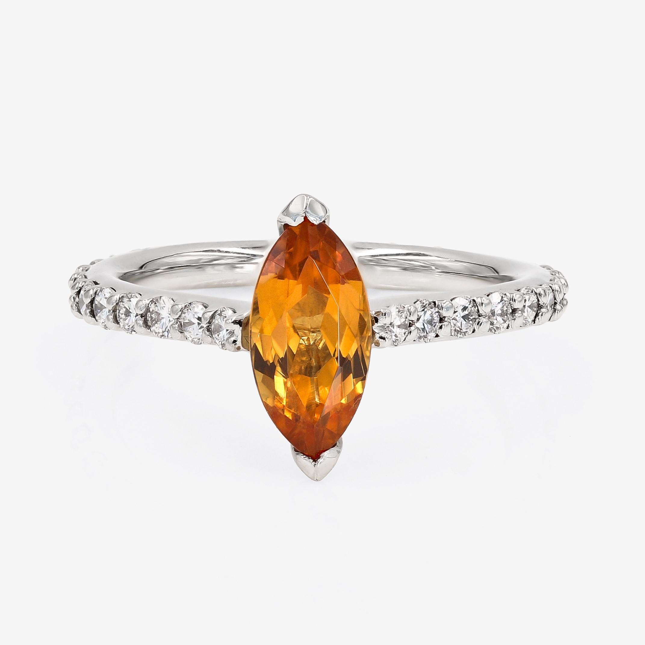 This ring contains a marquise shaped 1.45cts. Mandarin Garnet center. The shank contains 30 ideal cut round diamonds =0.63t.w. set in our comfort fit D-Bead™ setting style. The round diamonds are G in color and VS in clarity. The garnet is Nigerian