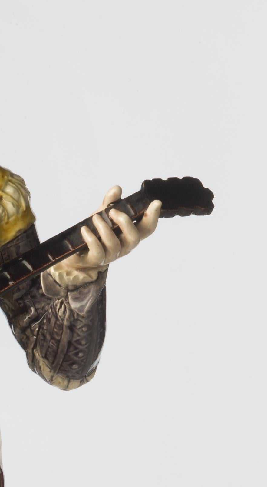 The last decades of the 19th century saw the relations between the Fine Arts, here sculpture, and the so-called industrial arts, earthenware production, flourish brilliantly. This Mandolin player is a perfect example. Created by the sculptor Adrien