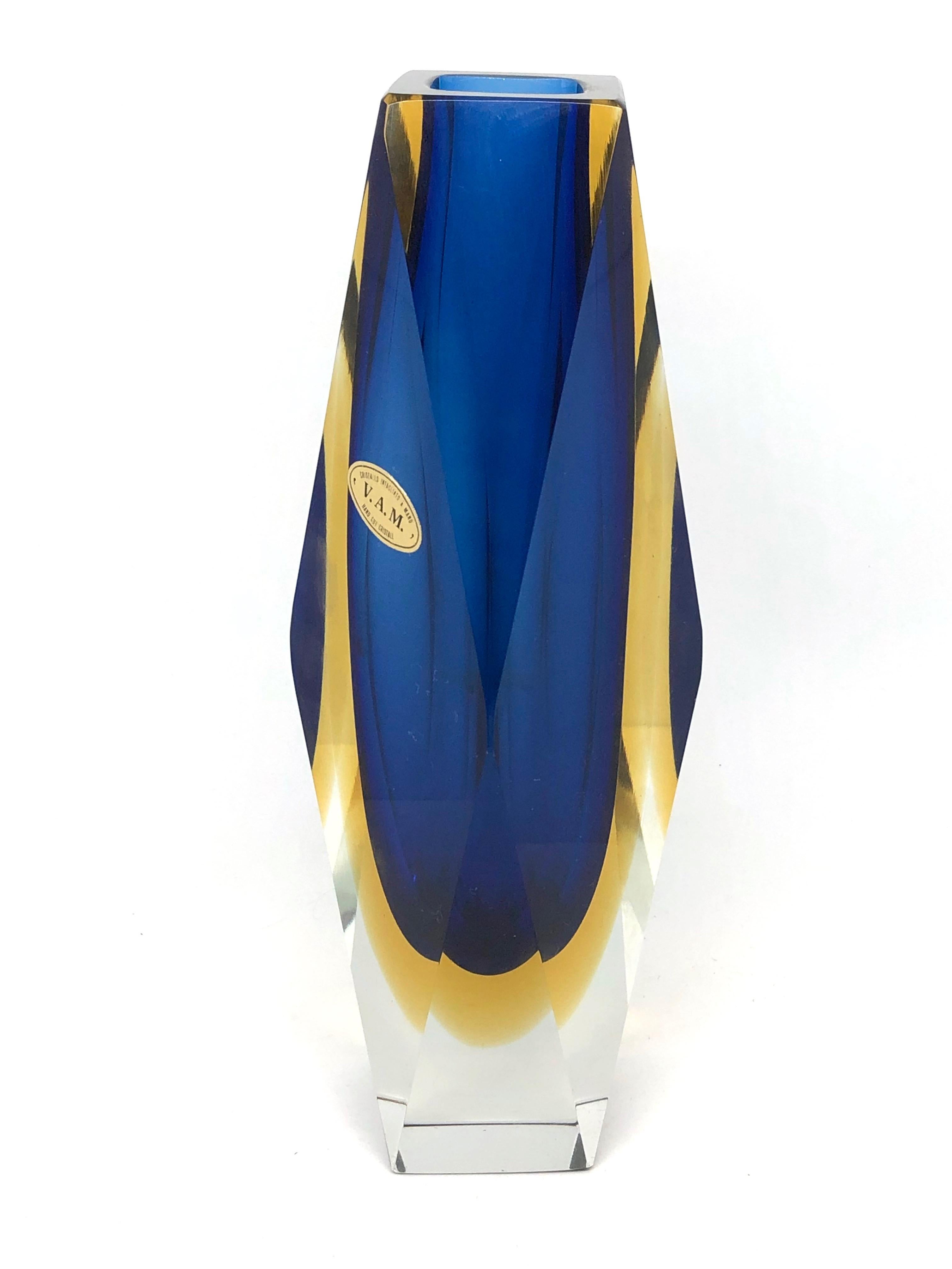 An amazing Venetian Murano glass Mid-Century Modern Mandruzzato vase made in Italy, circa 1960s. This is a heavy glass block vase. Blue on the inside followed by a layer of yellow within clear. The top of the vase is flat cut. Vase is in very good