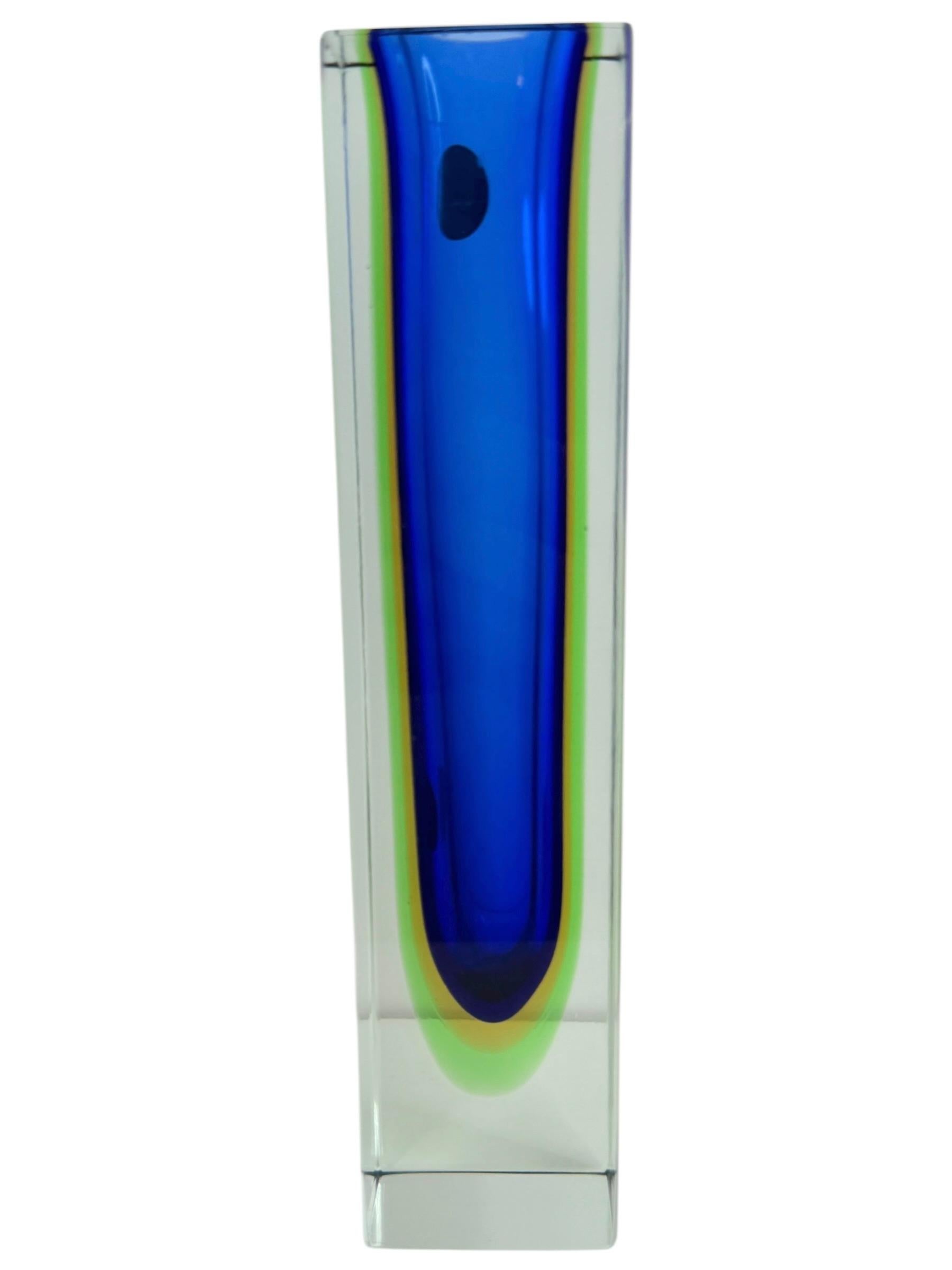 An amazing Venetian Murano glass Mid-Century Modern Mandruzzato vase made in Italy, circa 1960s. This is a glass block vase. blue, green and yellow within clear. The top of the vase is flat cut. Vase is in very good condition. Found at an estate