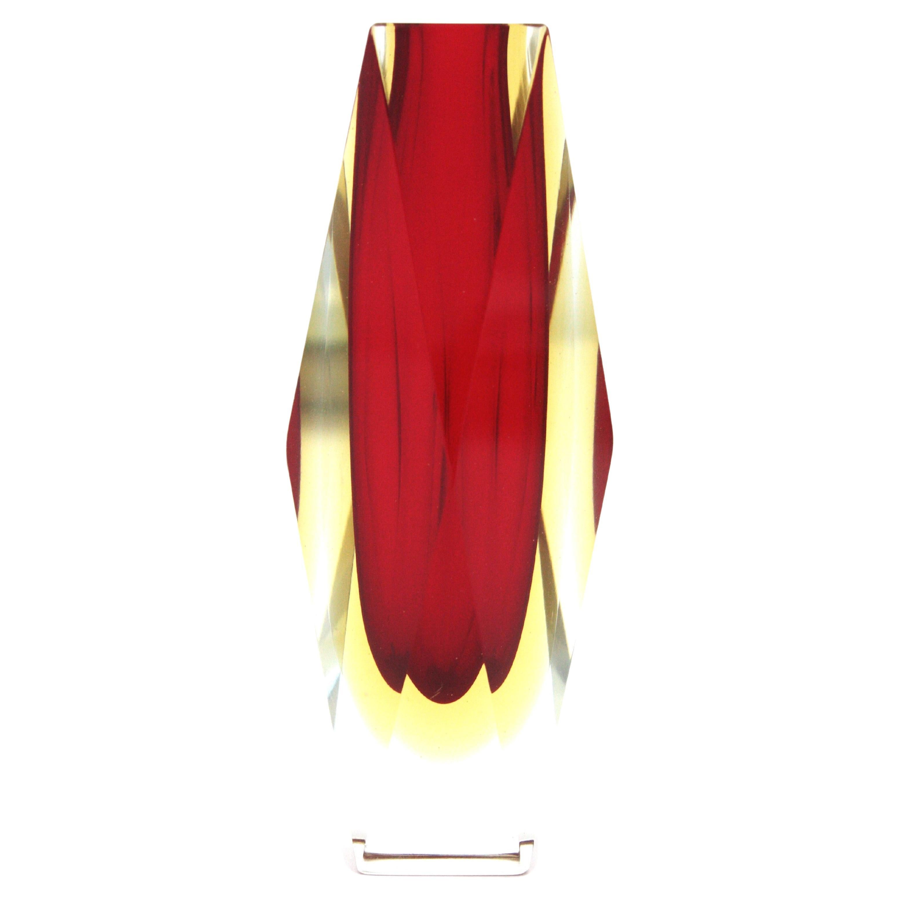 Faceted Sommerso double cased red and yellow Murano Art glass vase. Attributed to Mandruzzato, Italy, 1960s
Red glass with a layer of yellow glass cased into clear glass. The vibrant red color is eye-catching.
Beautiful to be used as flower vase or