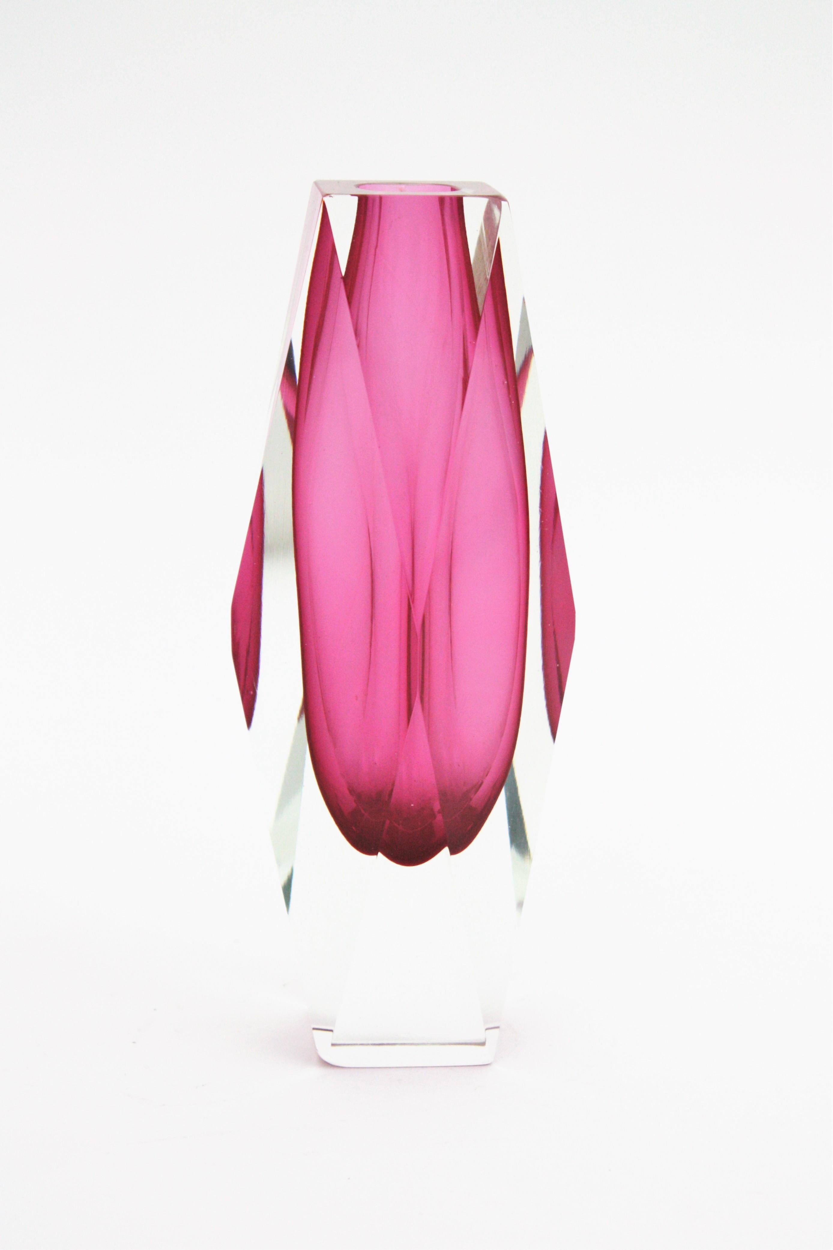 A colorful pink Sommerso Murano glass faceted vase attributed to Mandruzzato. Italy, 1960s.
Pink glass with a line in pink- fuchsia glass cased into clear glass.
Excellent condition. No chips, no cracks to notice. Beautiful to place with other