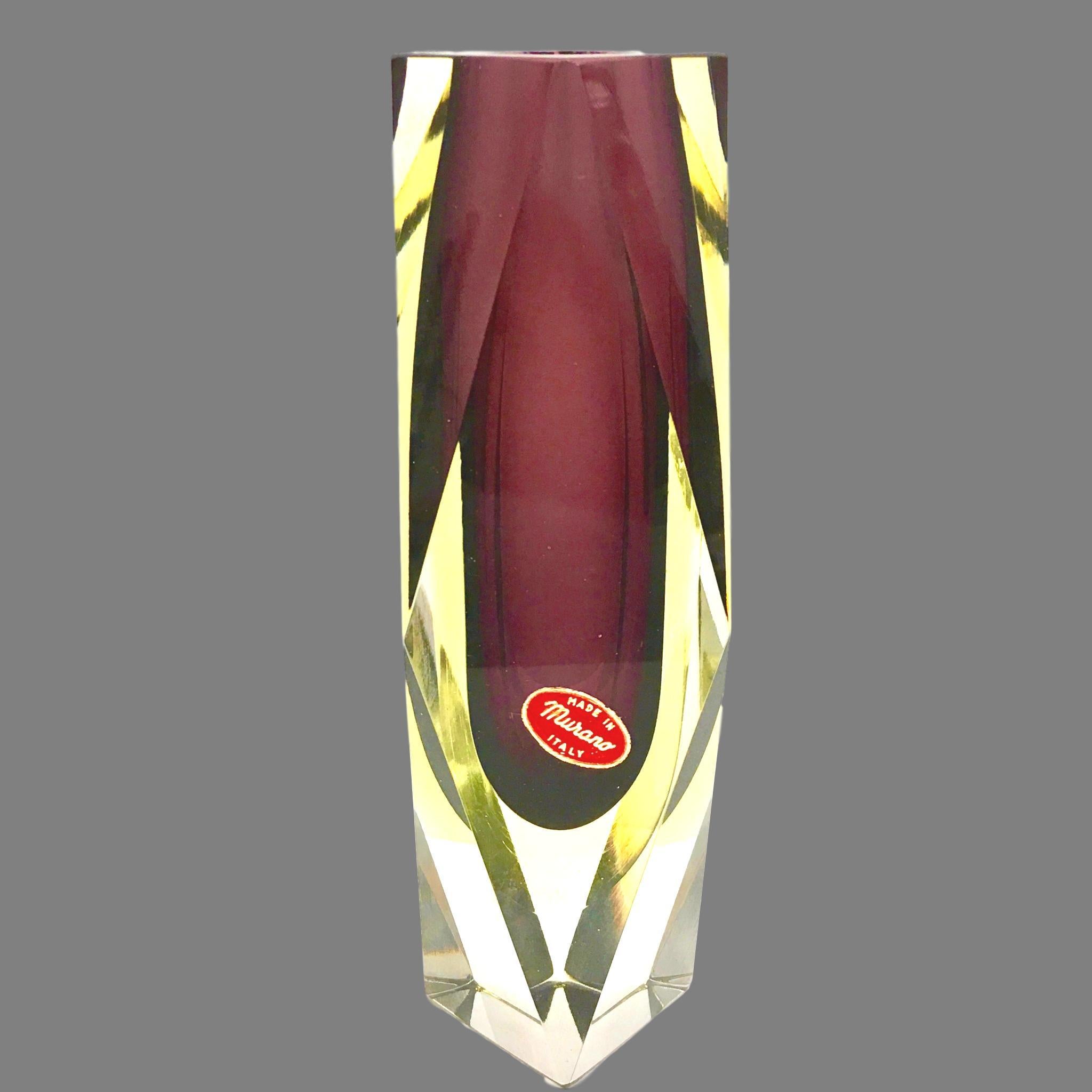 An amazing Venetian Murano glass Mid-Century Modern Mandruzzato vase made in Italy, circa 1960s. This is a heavy glass block vase. Purple on the inside followed by a layer of yellow within clear. The top of the vase is flat cut. Vase is in very good