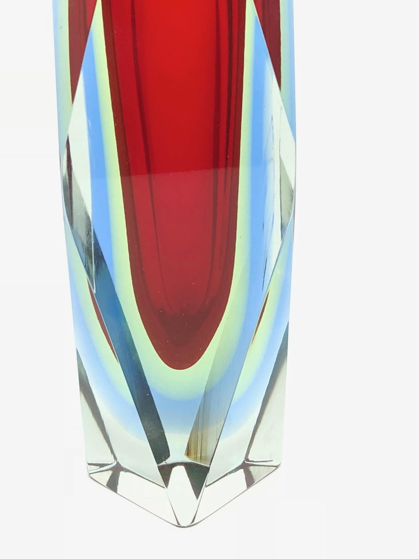 An amazing Venetian Murano glass Mid-Century Modern Mandruzzato vase made in Italy, circa 1960s. This is a heavy glass block vase. Red on the inside followed by a layer of green, blue within clear. The top of the vase is flat cut. Vase is in very