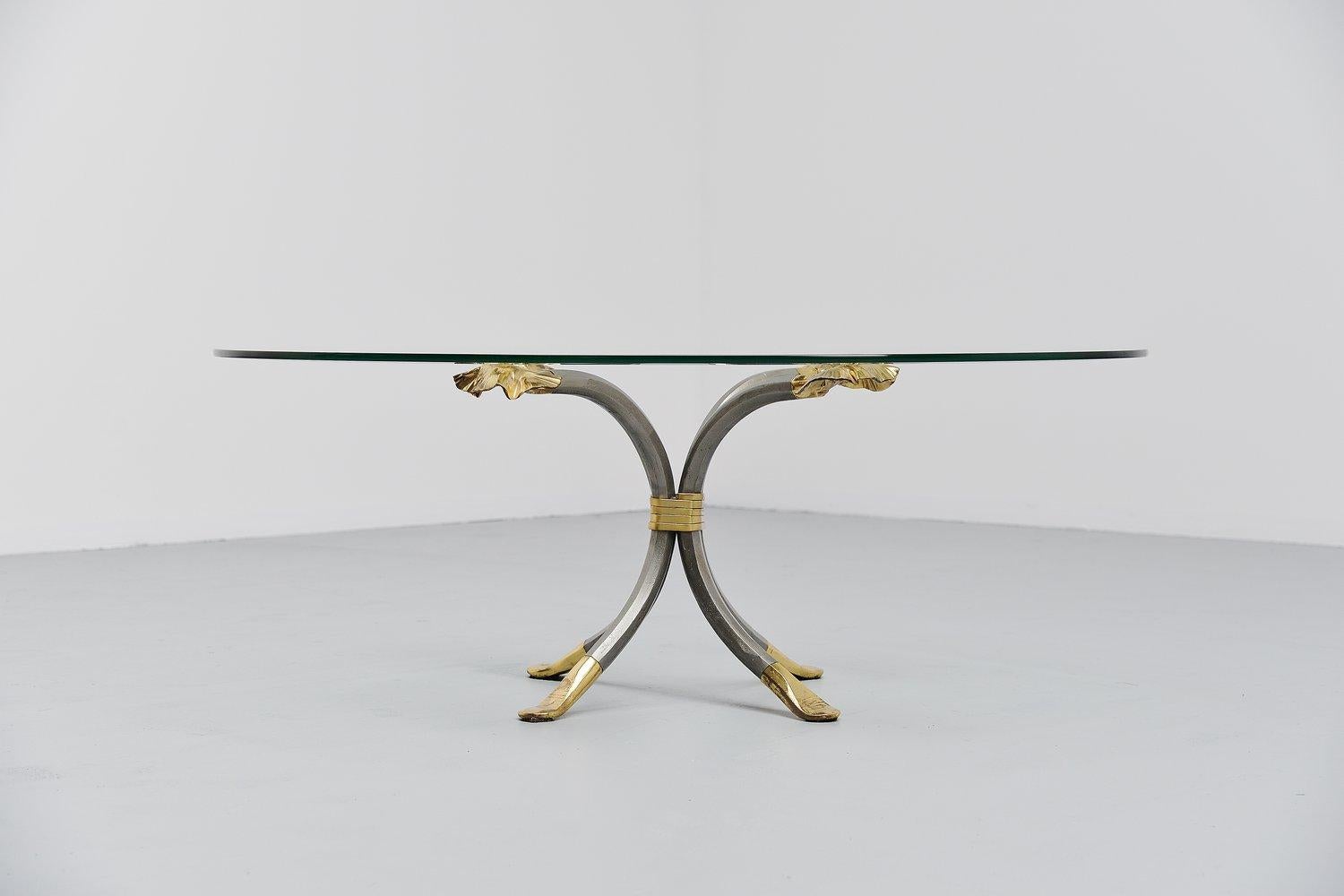 Very nice coffee table designed and made by the blacksmith Manfred Bredohl, Germany, 1970. This table has a lacquered iron base with brass details and an oval glass top. The table was stamped at one leg, Bredohl design. We have a pair of these