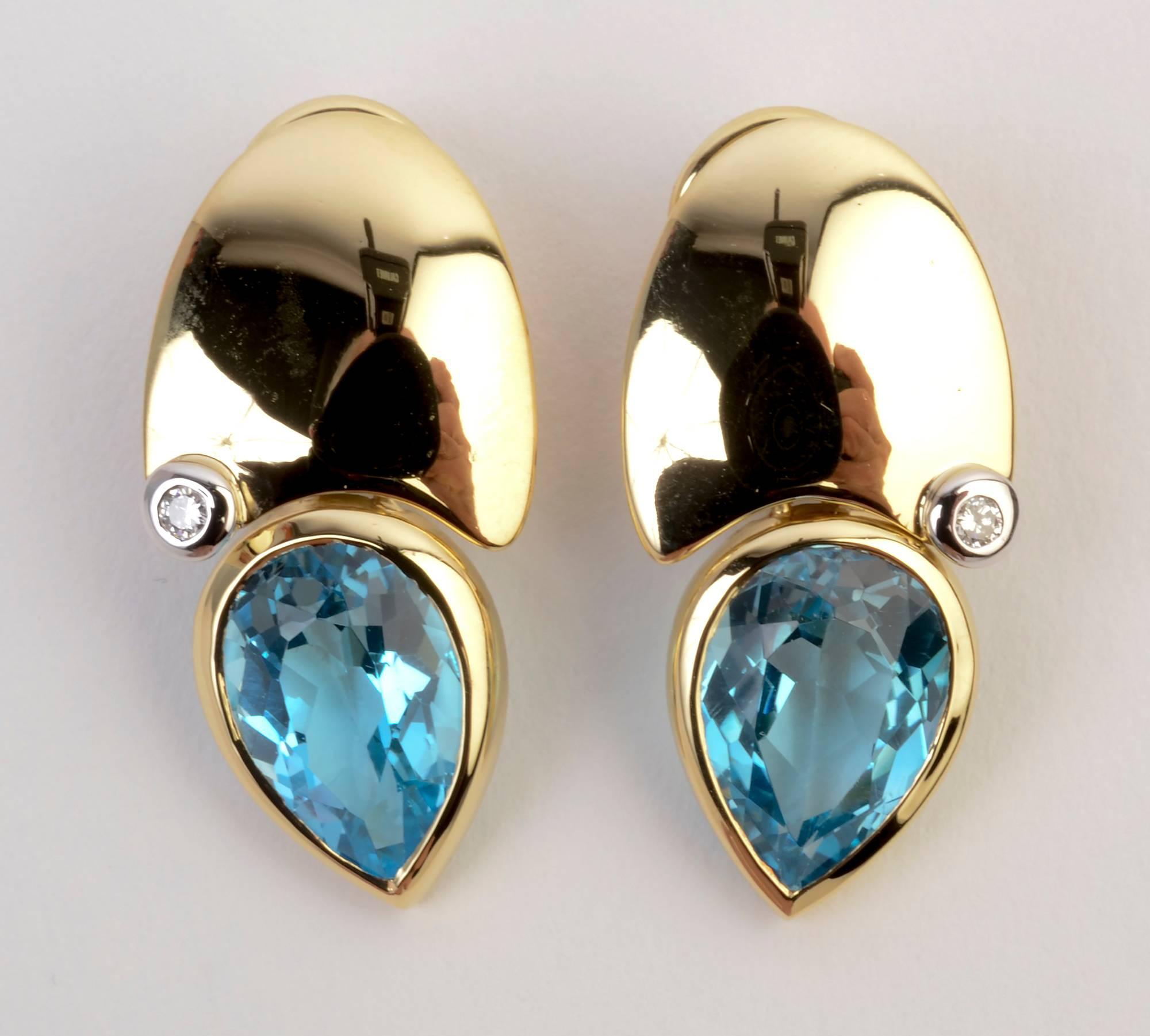 Manfredi made 18 karat gold earrings with a pear shaped blue topaz and a round diamond. The combined three shapes of the gold and the two stones make a very arty composition. The earrings are 1 1/4 inches in length and half an inch wide. Backs are