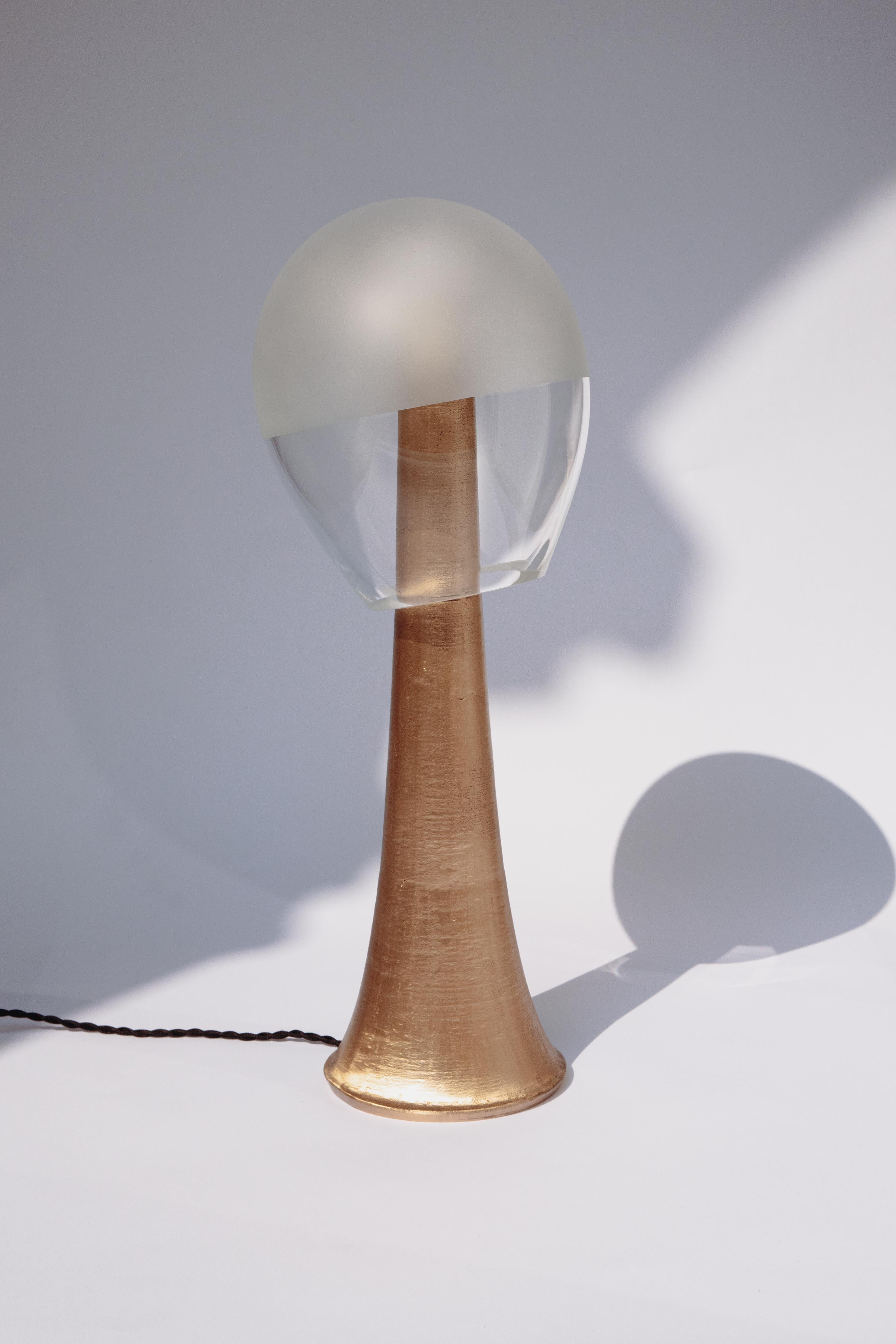 Mangaba Table Lamp by Clément Thevenot
Limited Edition Of 12 Pieces.
Designed by Clément Thevenot and Joyce Broussillou.
Dimensions: D 20 x W 20 x H 60 cm.
Materials: Nailed bronze, sandblasted glass, heat-resistant plastic diffuser system, driver