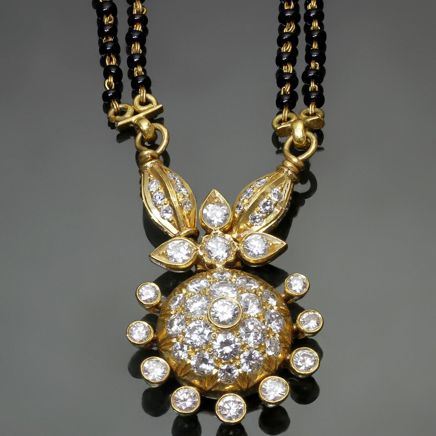 This gorgeous bridal Mangalsutra necklace is hand-crafted in 22k yellow gold and features 2 rows of black onyx beads completed with a sparkling pendant set with 68 round diamonds of an estimated 3.08 carats D-E-F color, VVS-VS clarity.
