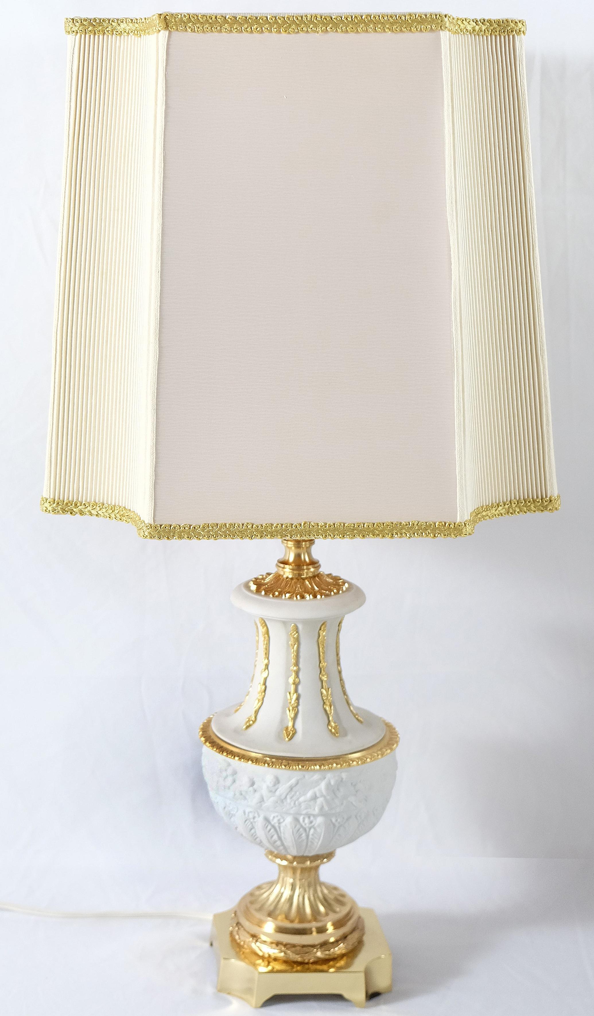 Mangani, Italy Classically Designed Porcelain Table Lamp Offered for sale is a classically designed Italian porcelain table lamp by Mangani. The lamp is created in porcelain with gilt neoclassical style details and is presented upon a bronze base