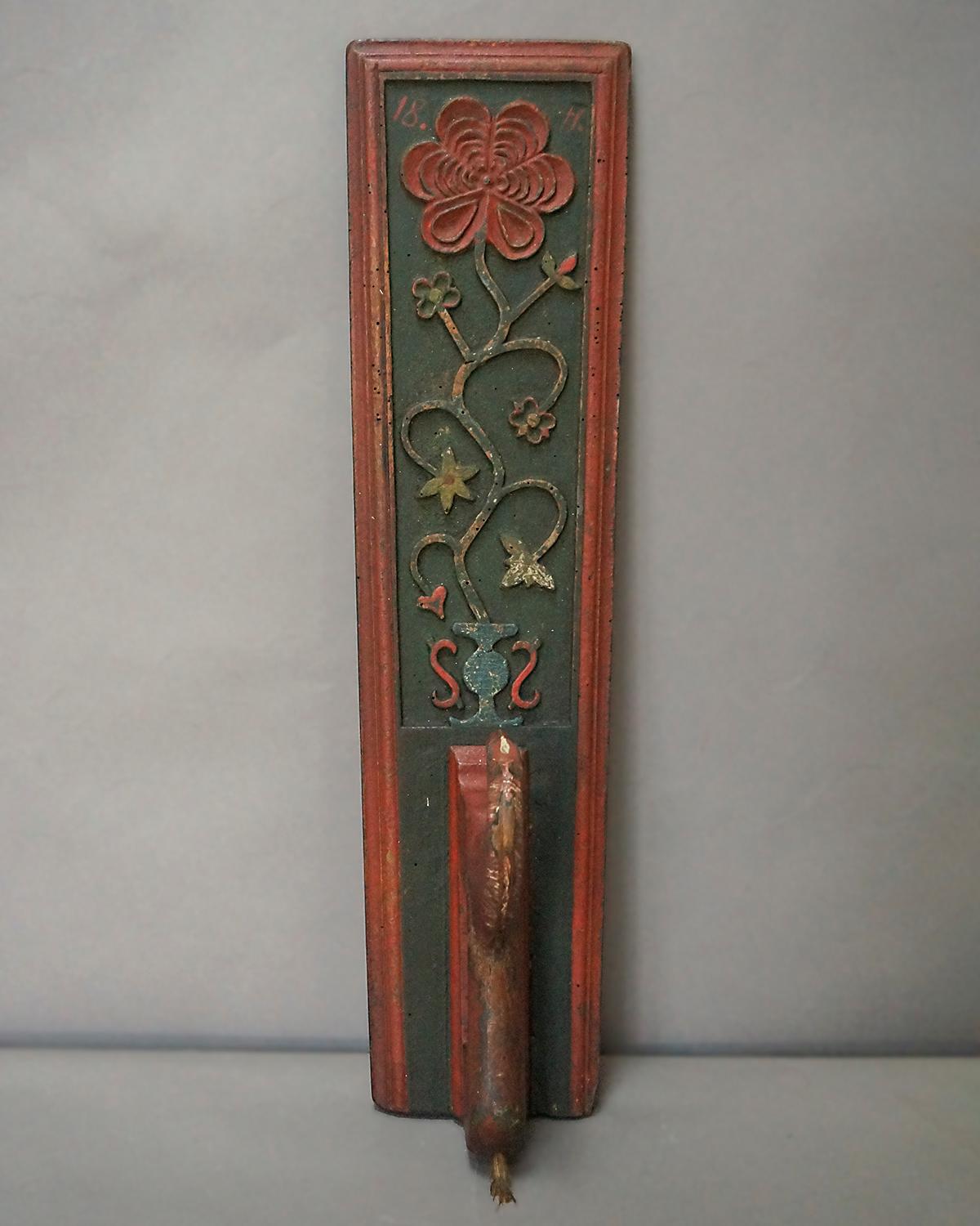 Danish mangle board dated 1841 with a horse handle. Beautifully carved flowering vine in an urn. Original painted surface with great patina.