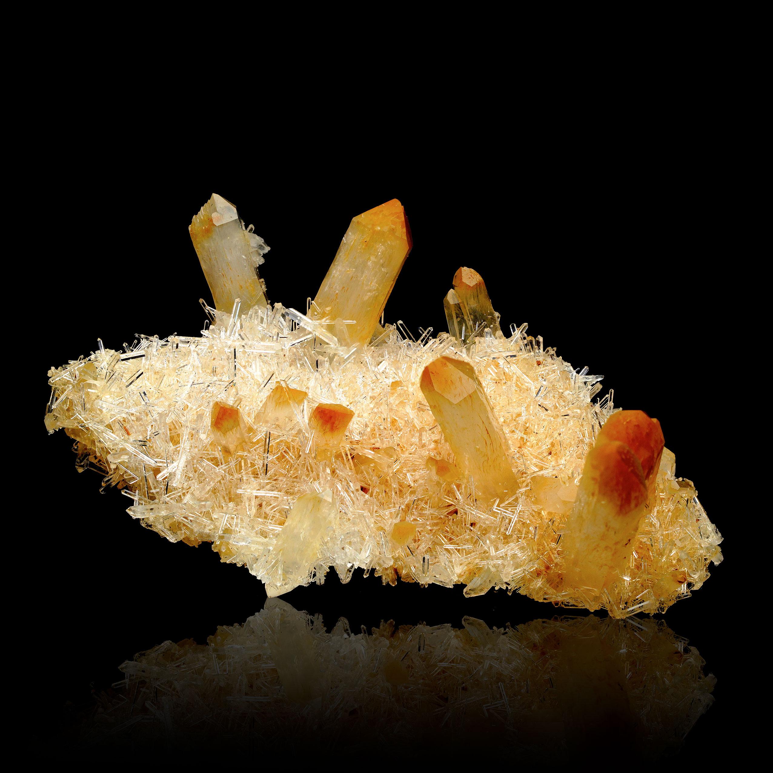This refined Mango Quartz with Halloysite specimen, Version V from Colombia, embodies the beauty of natural mineral formations in a delicate, petite size. Featuring the warm, sunlit hues characteristic of Mango Quartz and enhanced by unique