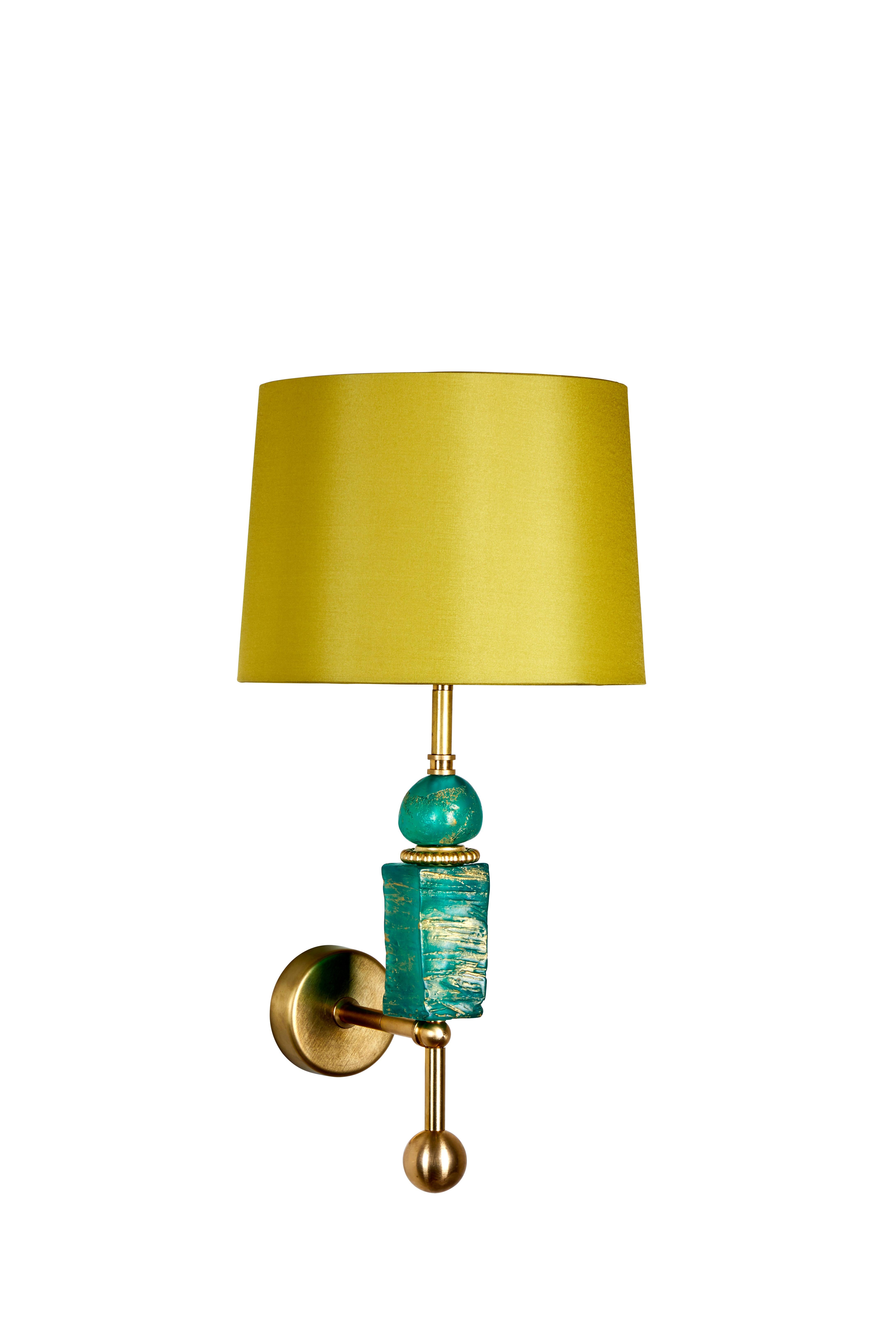 This Margit Wittig wall light with emerald resin hand-sculpted components is cast in her London-based studio.
The hand-patinated gold finish enhances the organic surface texture, a brass detail adds interest to this object of art which provides a