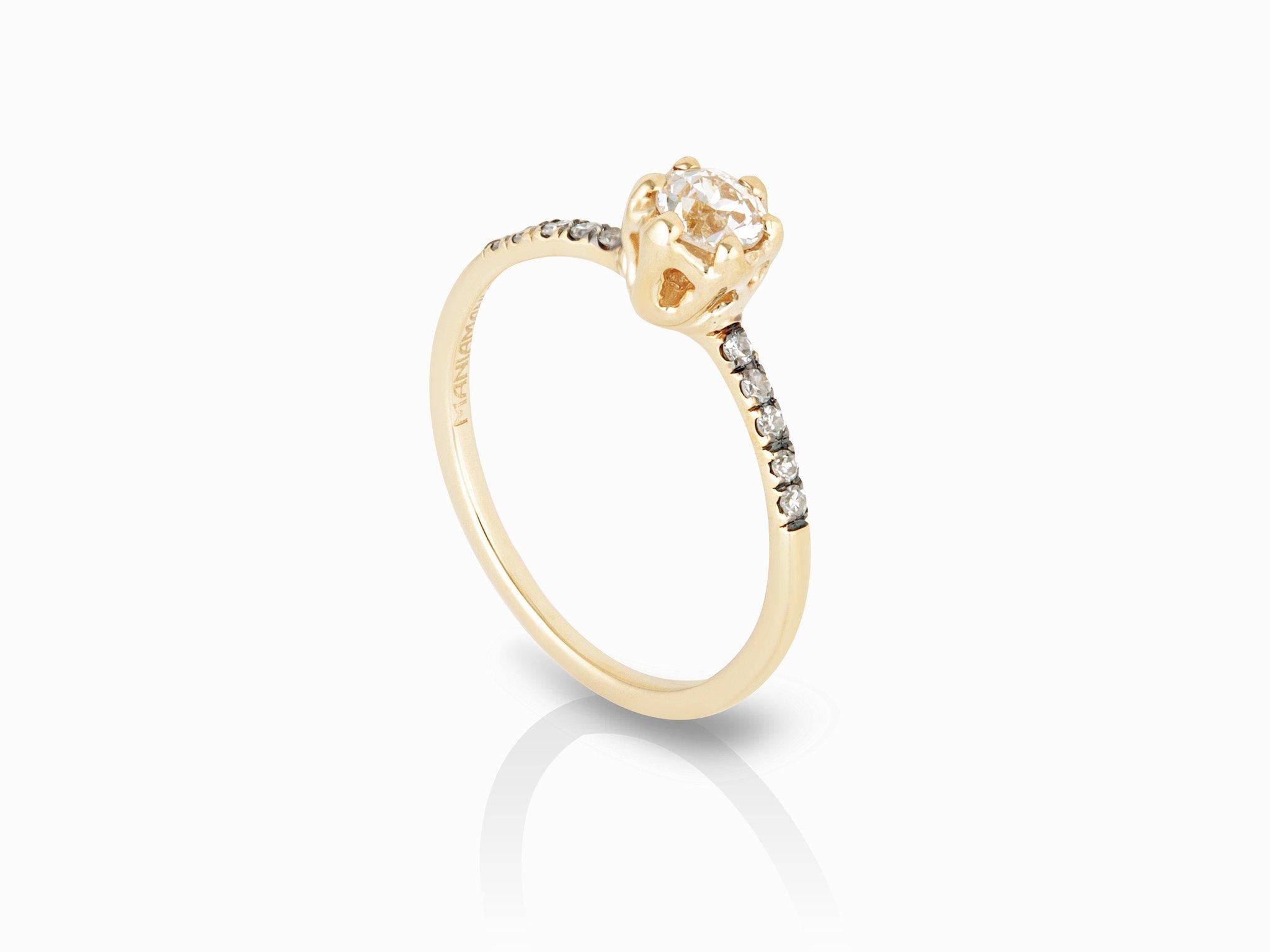 MANIAMANIA Entity Engagement ring in 14k yellow gold with White Diamonds ring with one 4mm round old European cut white Diamond (0.28-0.34ct), with pave of white Diamonds (.1ctw). Size 5.75.

Hand made in NYC, the 14k gold Entity ring features an