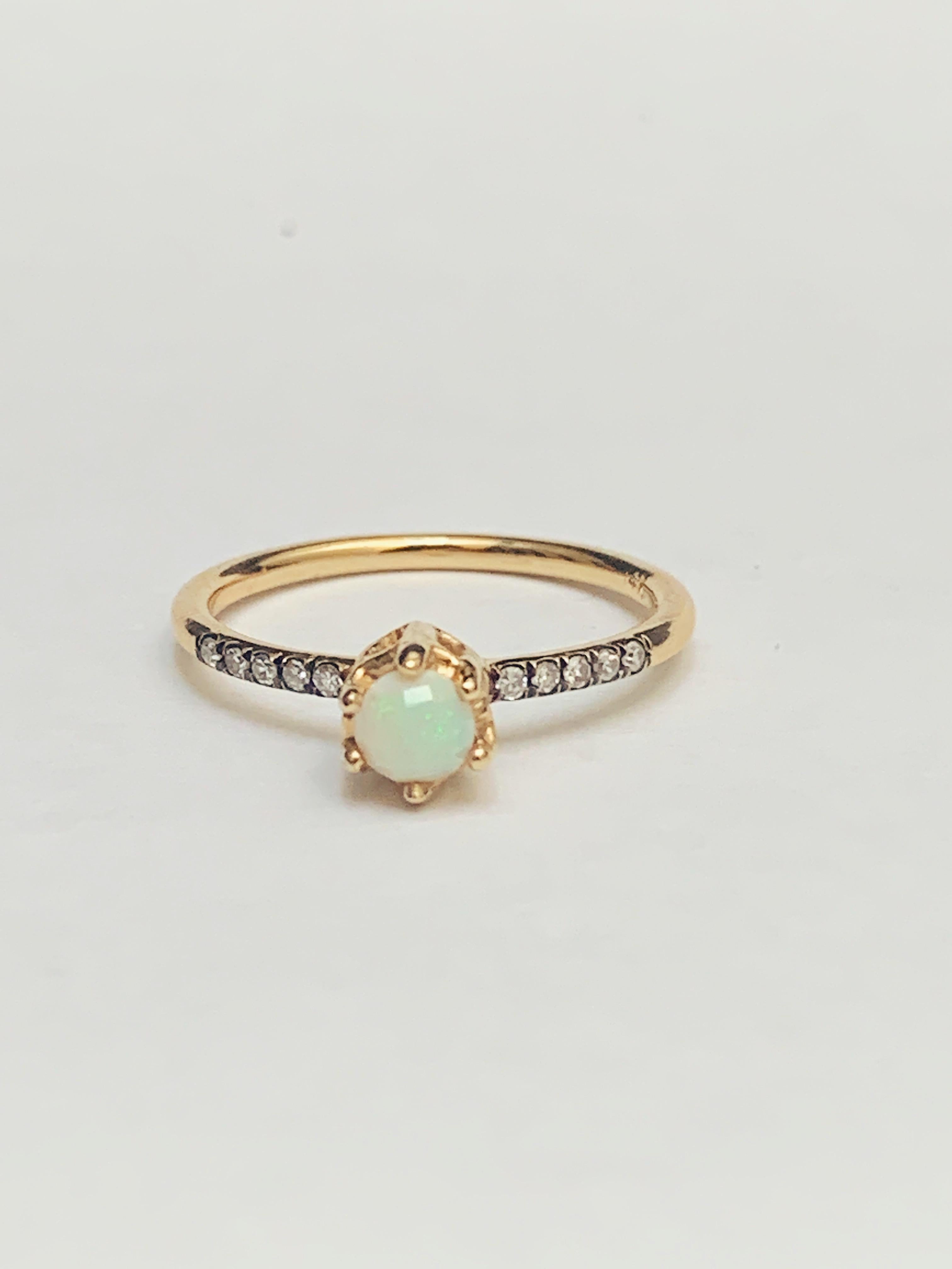 MANIAMANIA Entity Engagement ring in 14k Gold, a 4mm round custom rose cut Australian Opal, with a pavé of white Diamonds (.1ctw) . Size 6.5.

Hand made in NYC, the 14k gold Entity ring features an ornate basket setting on a delicate pavé diamond