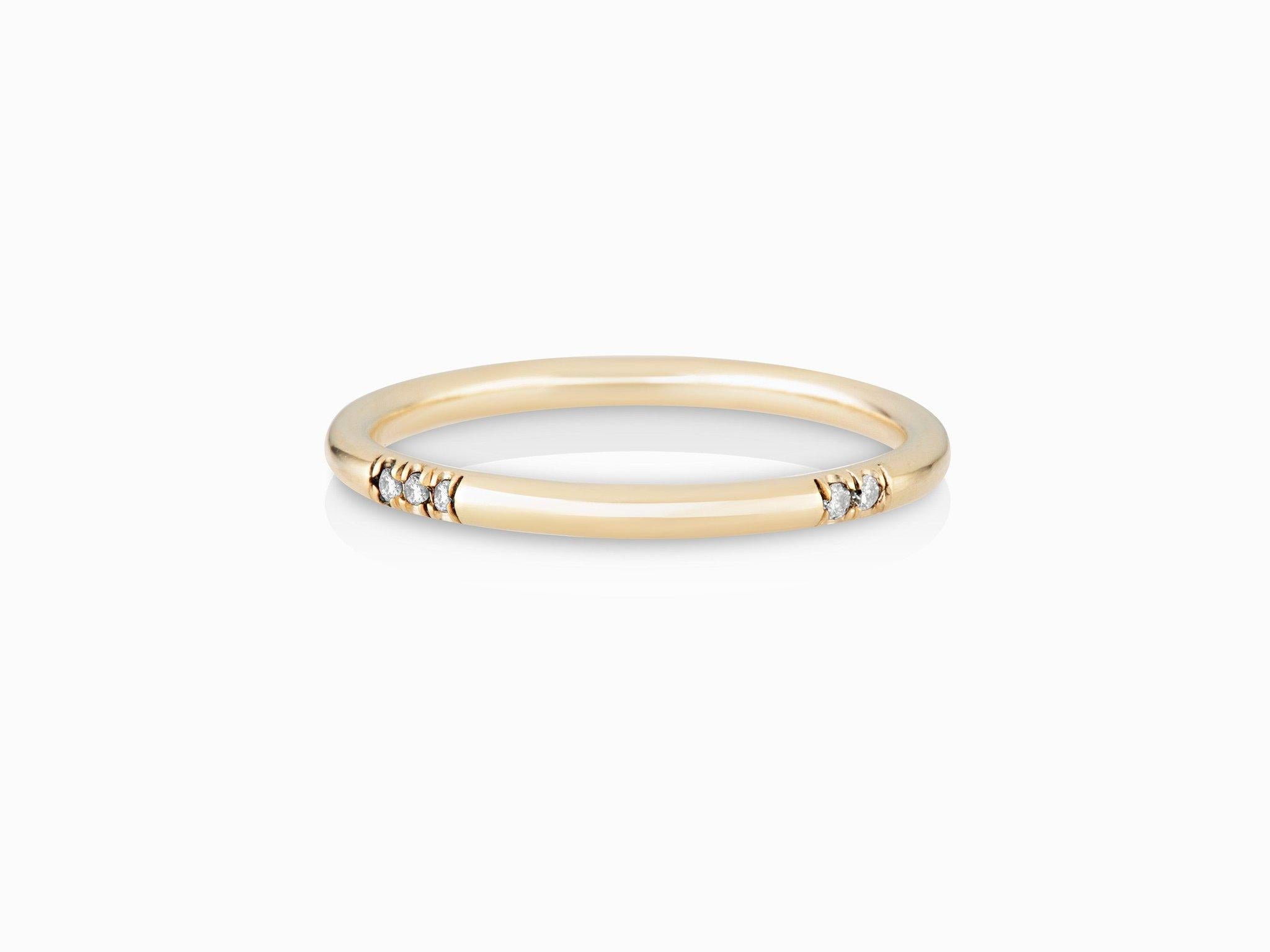 MANIAMANIA Immersion Wedding ring or Stackable band in 14k Yellow Gold, featuring one 3x1mm baguette white diamond (0.03 ct) and pavé accents of white diamonds (0.08tcw).
Size 6
*Other sizes can be made to order on request, with 5-6 week lead