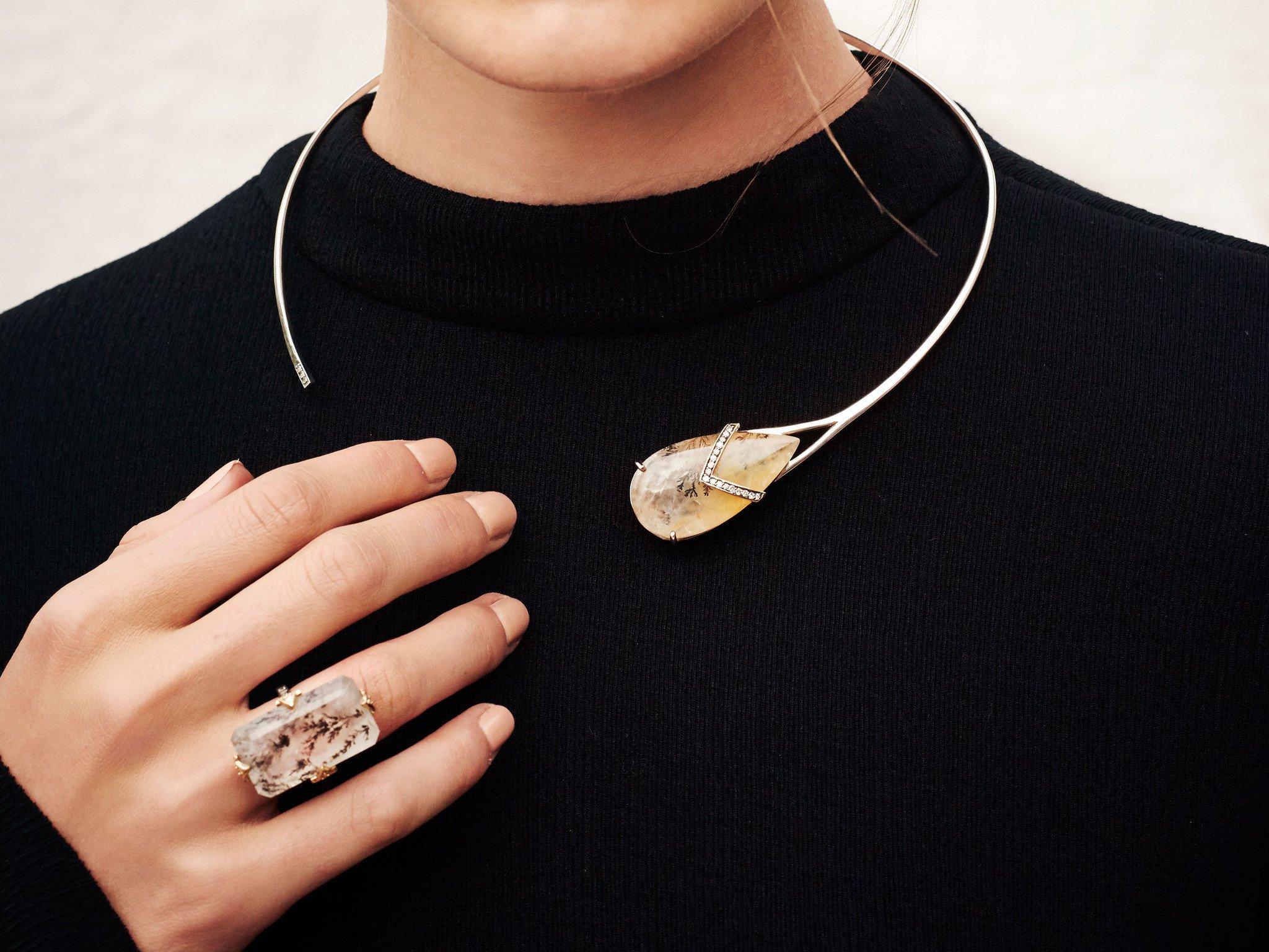 MANIAMANIA Phenomena Neckpiece in Sterling silver with large Pear shaped Dendrite Quartz stone, set with 14k yellow gold band setting with a pavé of white diamonds,  and white diamond detail on end.

This mixed metal statement neckpiece was hand