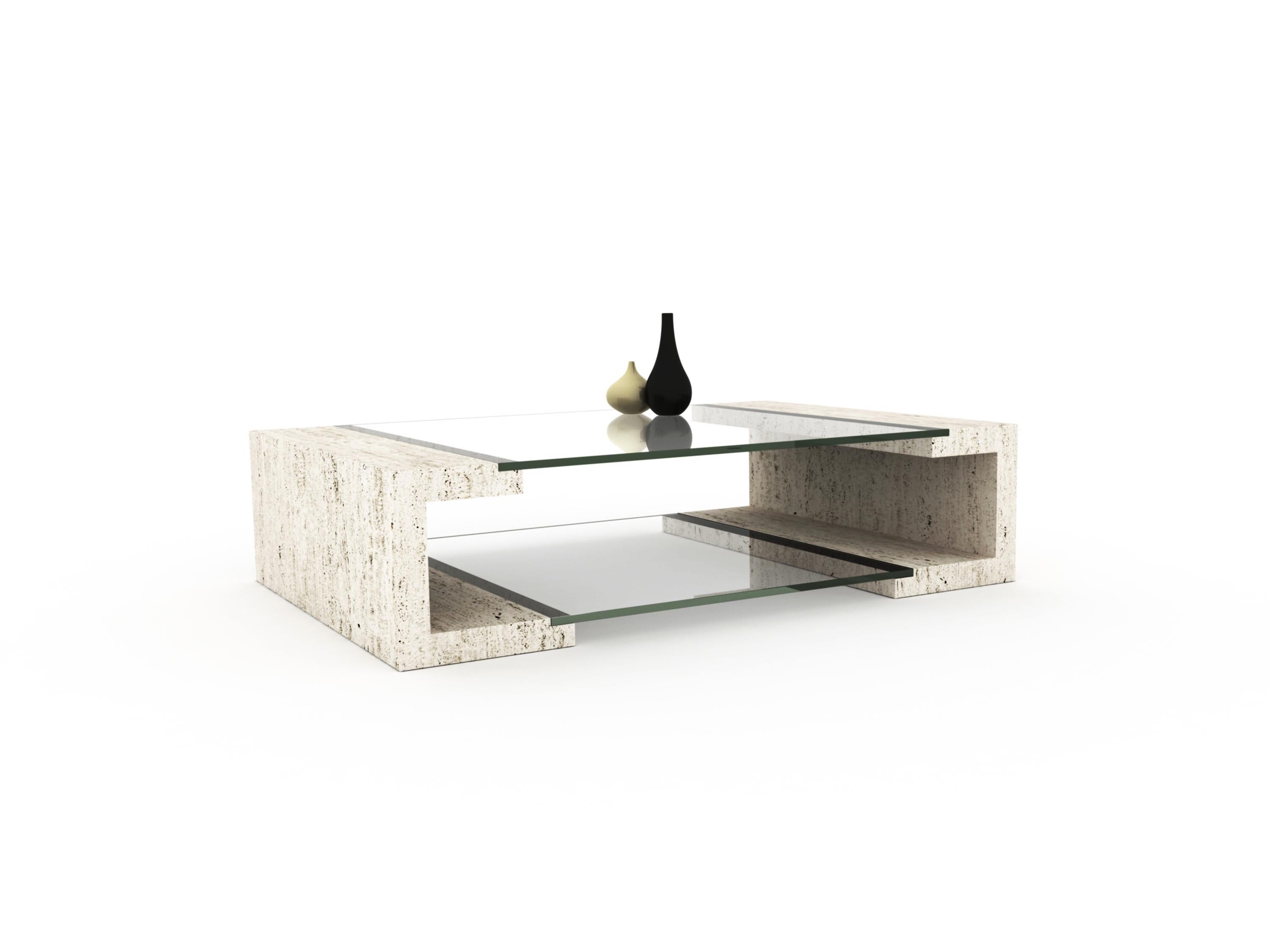 MANILA is a coffee table in natural Roman travertine marble with a detail of two crystals, one on the surface and the other in the magazine rack. The structure is hollow and has light and symmetrical lines which makes the design of this coffee table