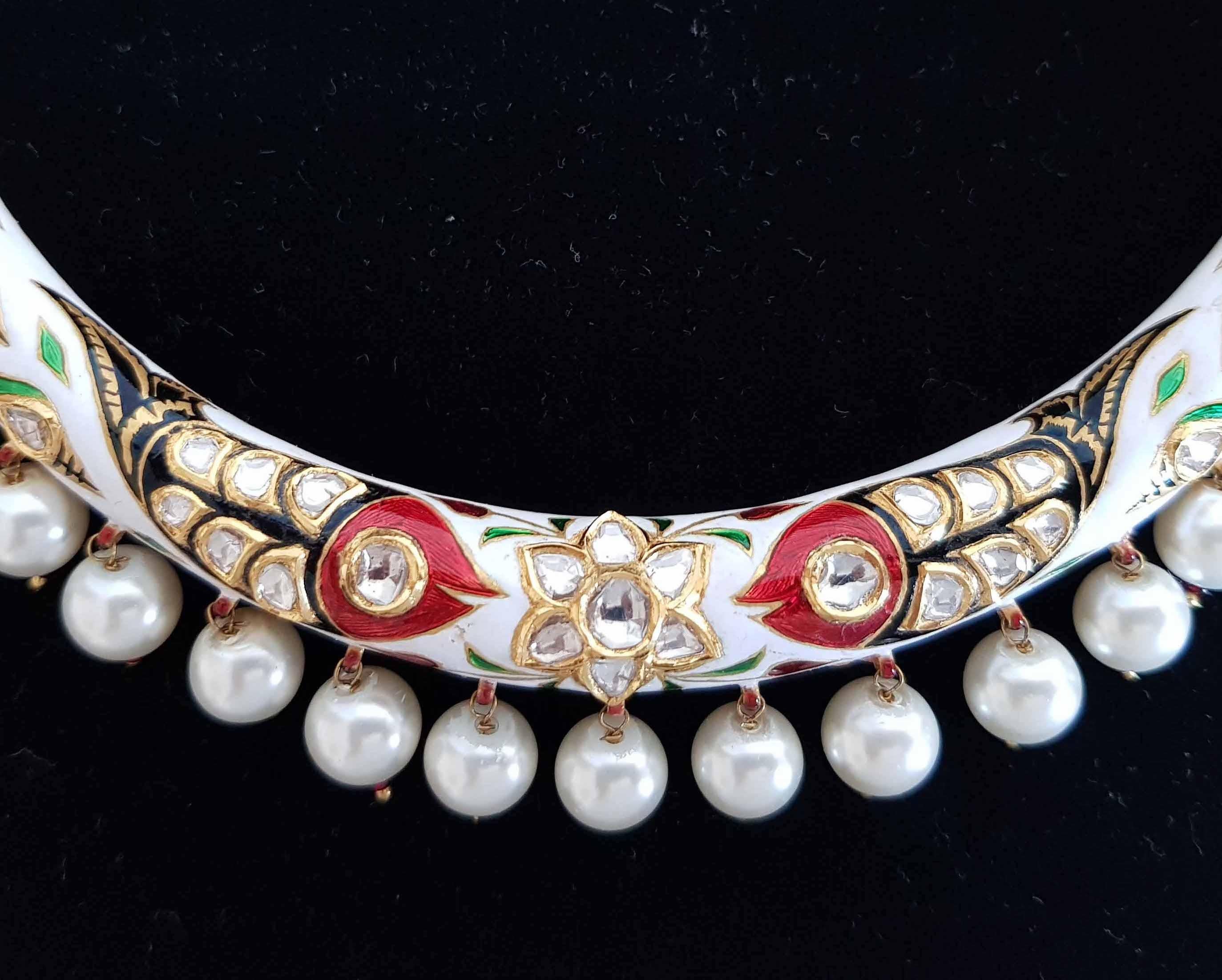 The epitome of feminine style and sophistication, this intricate handcrafted necklace is made in 22k gold featuring polkis (uncut diamonds) in the centre of motifs. Accentuated with Pearl drops and work at the back of necklace.
Adjustable at the