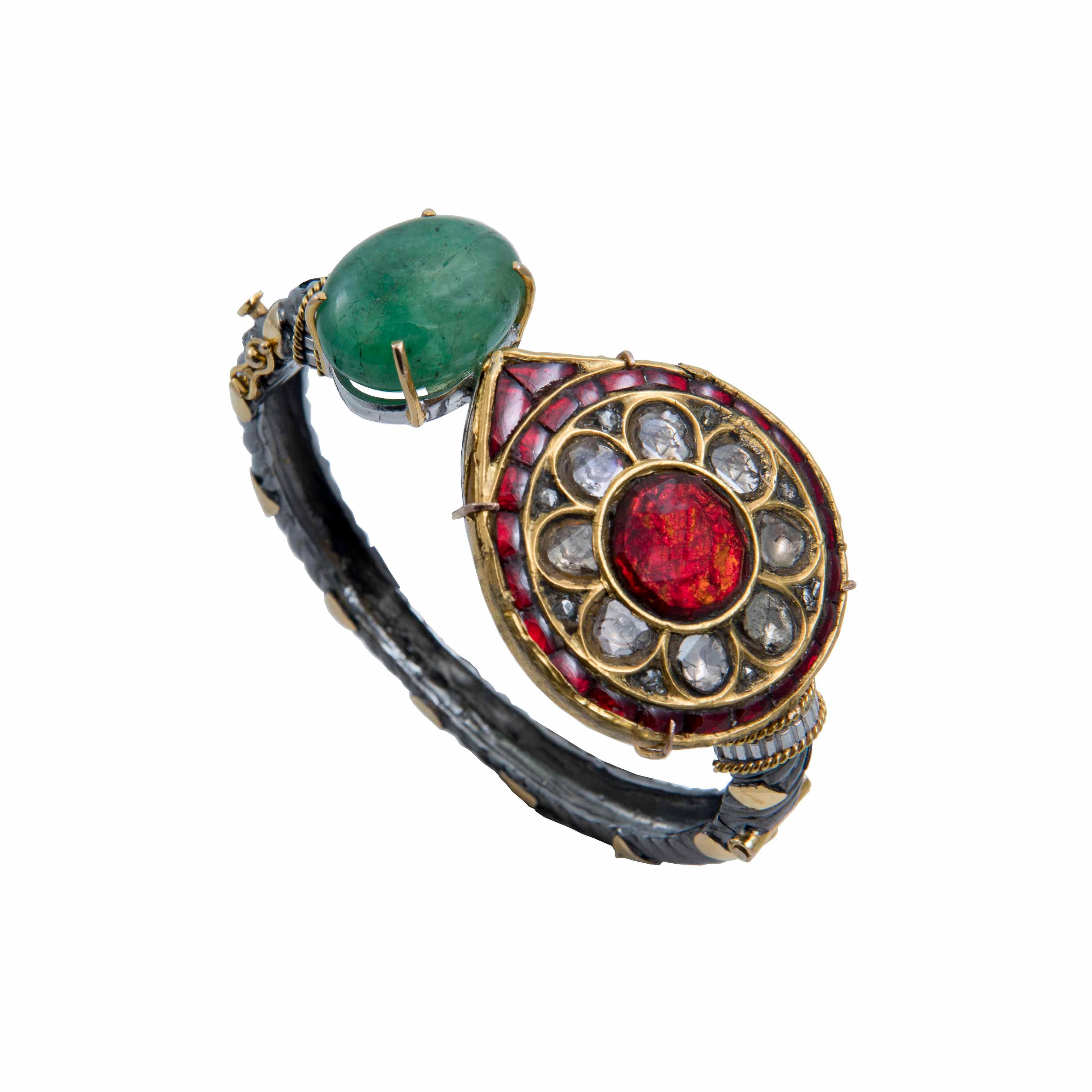 This bracelet from Iconic series of the brand, showcases a flirty interplay of black chrome plated pure silver band with 18k gold work on it, and a handcrafted Ruby and Polki (uncut diamonds) vintage finish centrepiece Paisley set in 18k gold.