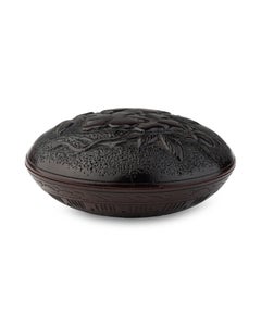 Manju nestuke in hardwood carved with a cherry blossom and geometric pattern