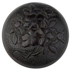 Manju nestuke in hardwood carved with a cherry blossom and geometric pattern