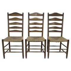Manner of E Gimson. A set of three lovely quality oak ladderback dining chairs