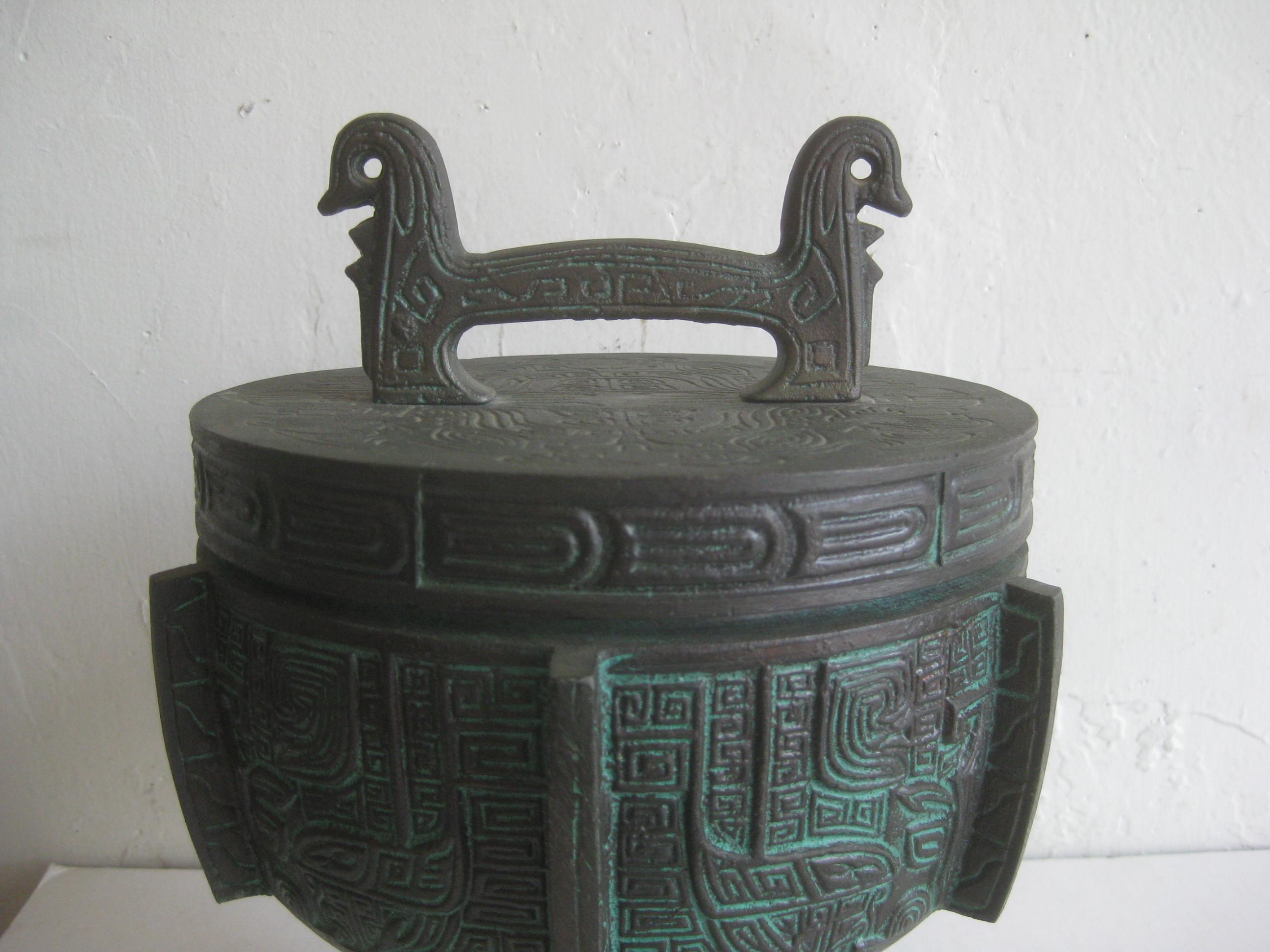 Great ice bucket in the manner of James Mont, circa 1960s. Has a Chinese/Asian design with a verdigris finish. Ice bucket is in excellent shape with very light use over the years. Made of metal with a bronze patina finish. Great painted green