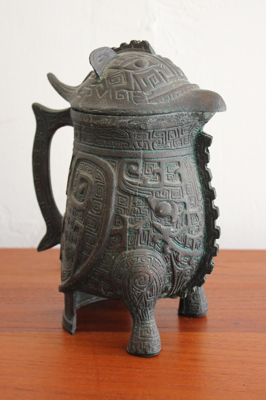 Great water pitcher in the manner of James Mont, circa 1960s. Has a Chinese/Asian design with a Verdigris finish. The water pitcher is in excellent shape with very light use over the years.
Measures 7 1/2