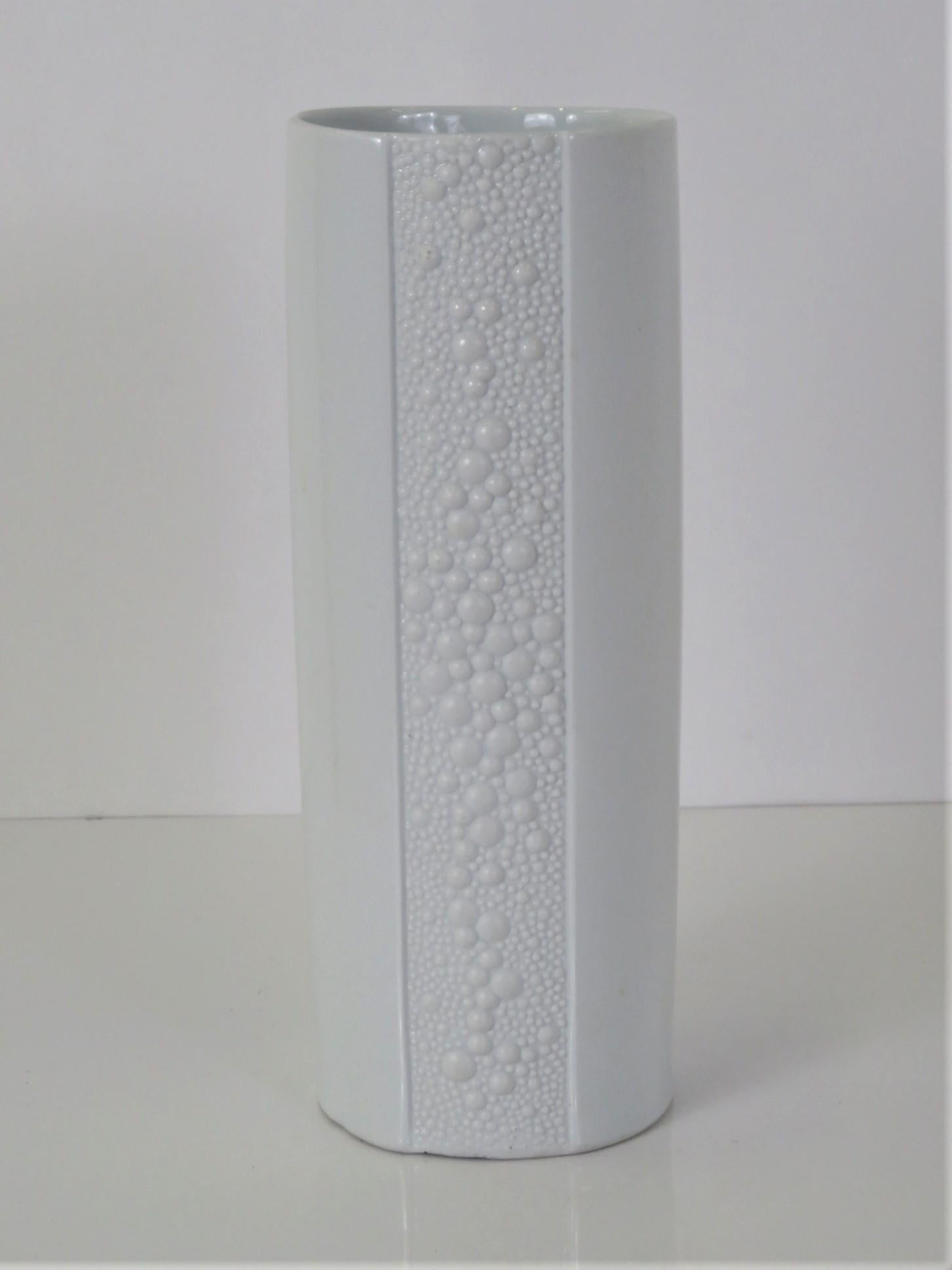Combination of matte & glossy white glazing makes this modern and beautiful tall Vase much more interesting. The band of matte white in the center front and back has a raised decoration of bubbles reminiscent of the work of Tapio Wirkkala for