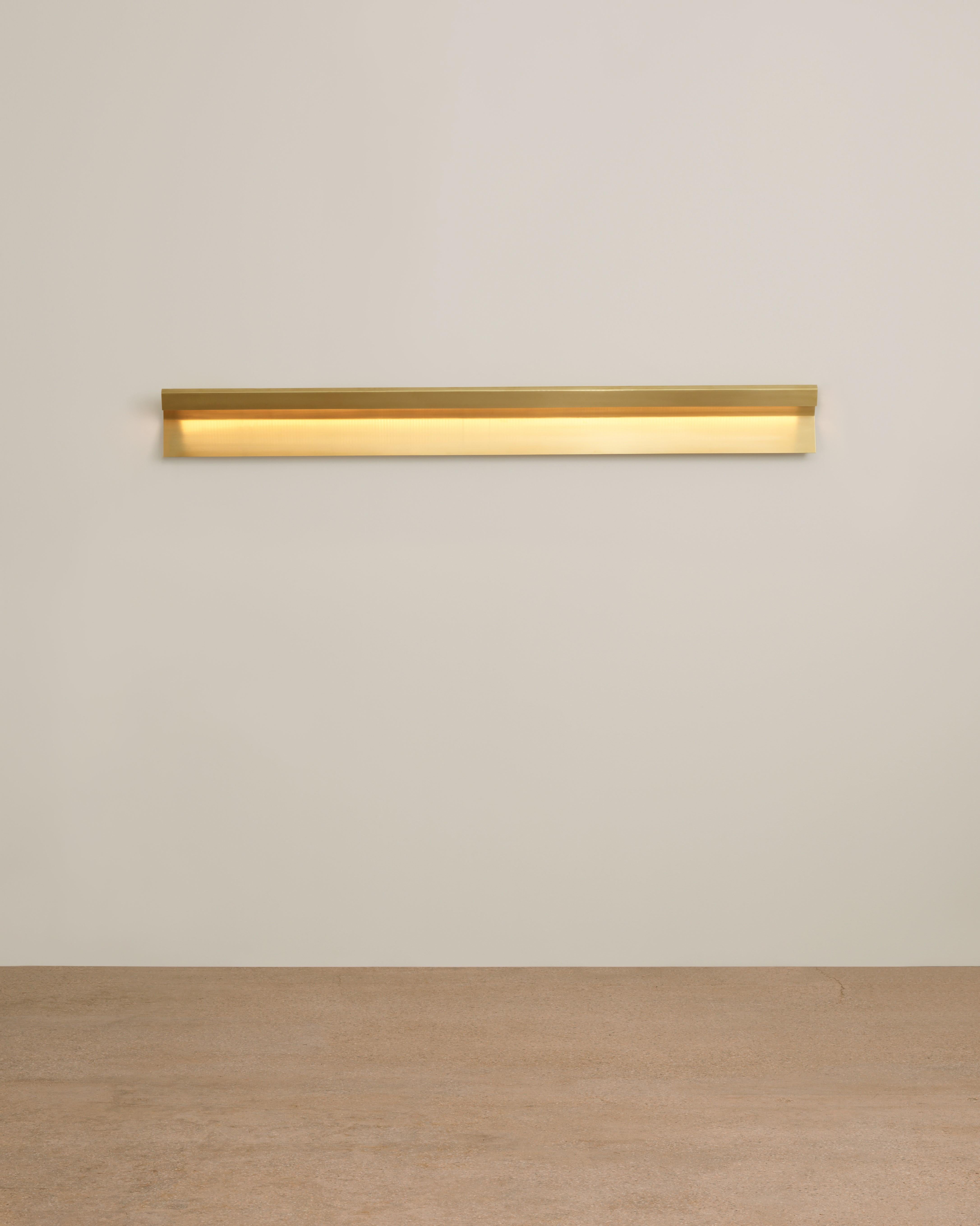 Mano wall-down lamp by Umberto Bellardi Ricci
Dimensions: W183 x D7.6 x H17.8 cm
Materials: Brasse, aluminium wall fixing, led strip in aluminium casing, 24V Driver.

All our lamps can be wired according to each country. If sold to the USA it