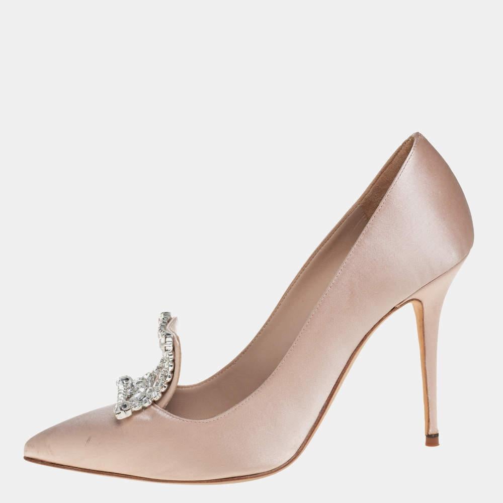 Walk with grace and confidence in these Borlak pumps by Manolo Blahnik. Styled as a pointed toe, with gorgeous crystal embellishment on the vamps, leather lining, and 11 cm high stiletto heels, this beige satin pair will never fail to lift your