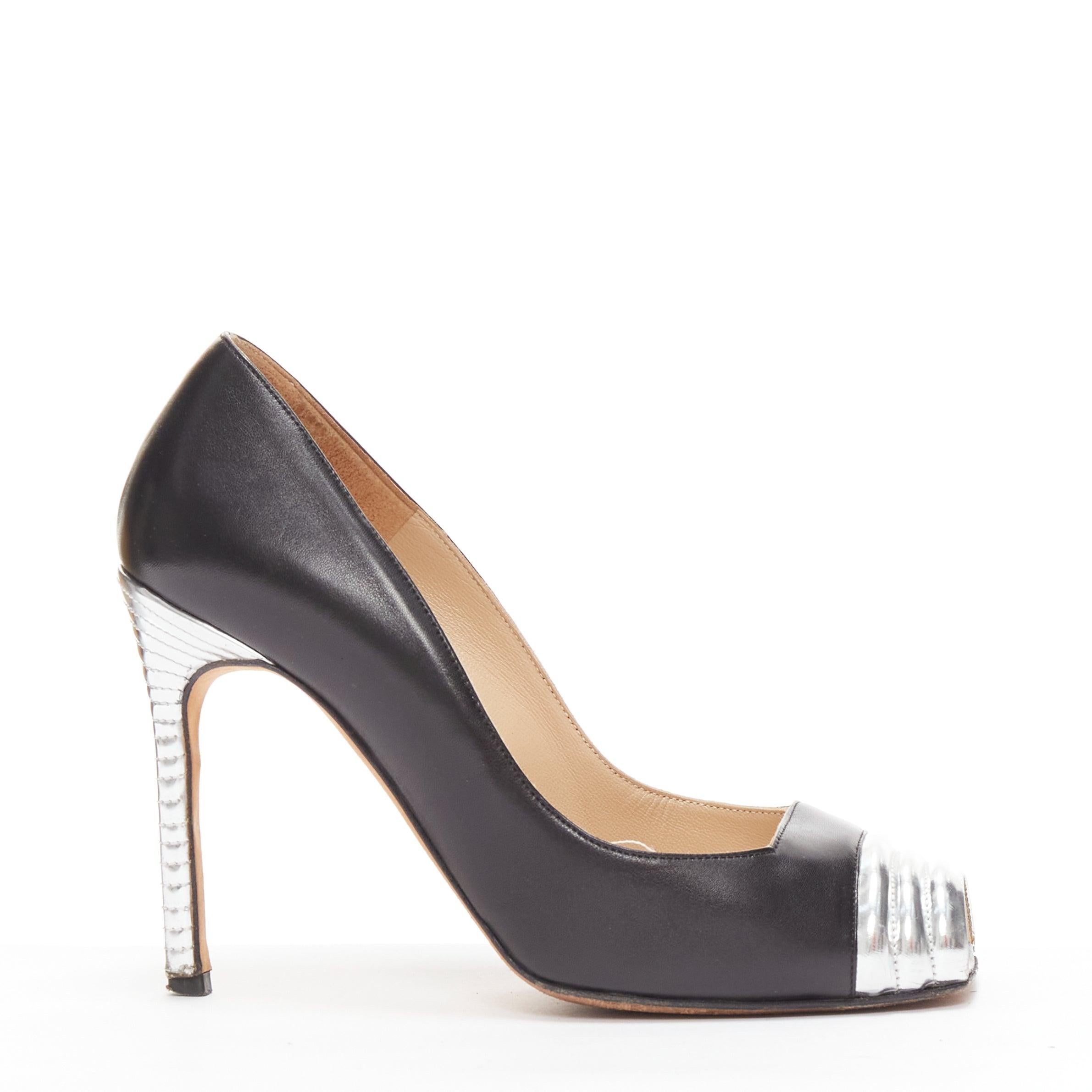 MANOLO BLAHNIK black leather silver quilted blunt peep toe pumps EU37
Reference: LNKO/A02290
Brand: Manolo Blahnik
Material: Leather
Color: Black, Silver
Pattern: Solid
Closure: Slip On
Lining: Nude Leather
Extra Details: Silver quilted heels.
Made