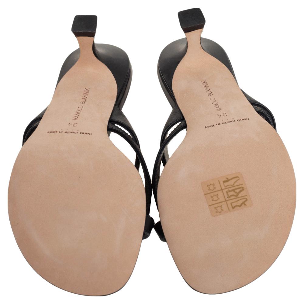 These Manolo Blahnik sandals are a reflection of the label's immaculate artistry in shoemaking. Crafted from black leather, they are adorned with slender straps and comfortable heels. Style them with workwear and look effortlessly
