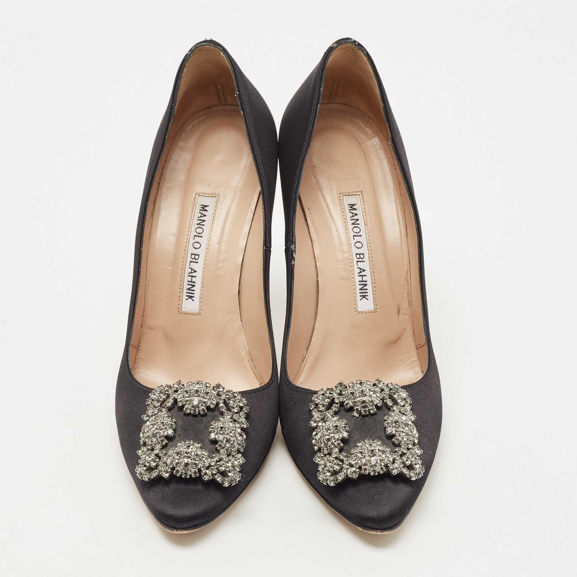 The 10cm heels of this pair of Manolo Blahnik pumps will reflect grace and luxury in every step. Made from satin, it is made striking with crystal-embellished buckle detailing on the toes and exhibits branded insoles.

