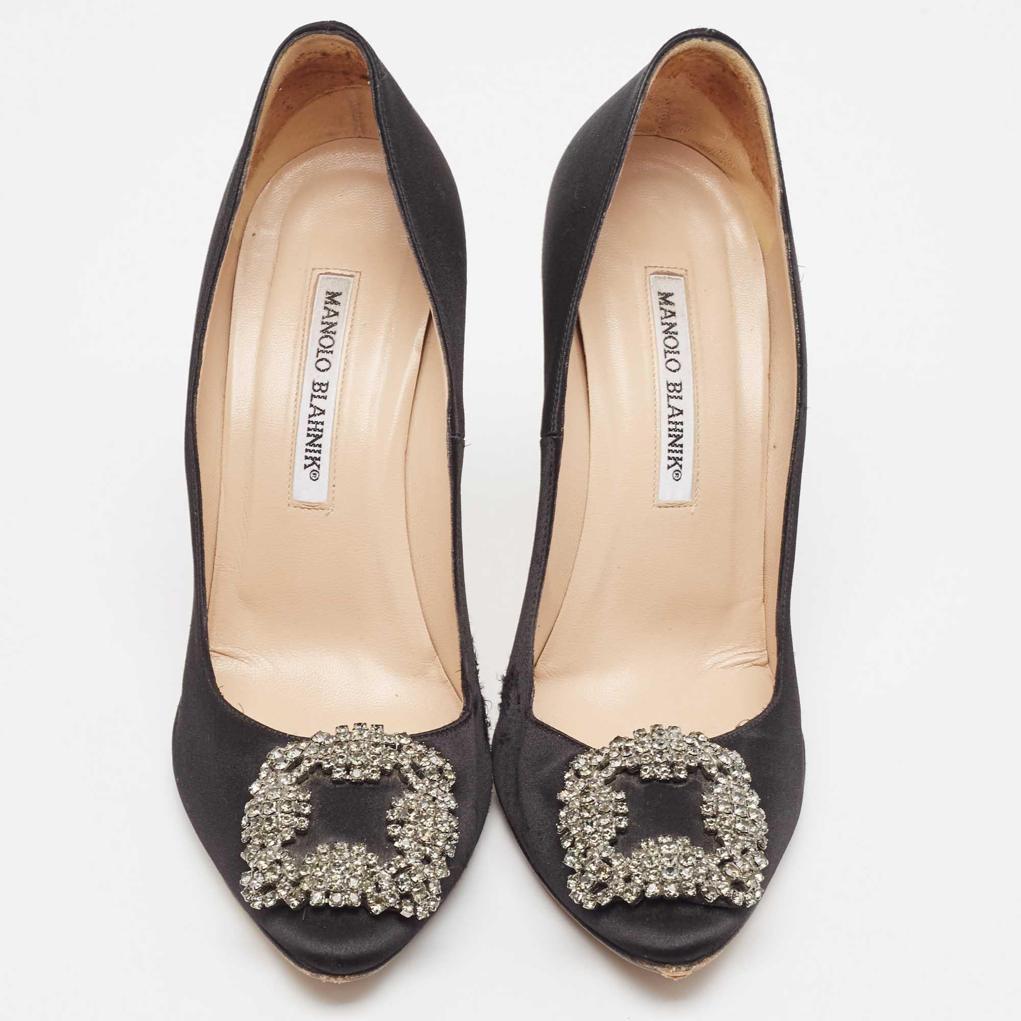 The 11.5cm heels of this pair of Manolo Blahnik pumps will reflect grace and luxury in every step. Made from satin, it is made striking with a crystal-embellished buckle detailing on the toes and exhibits branded insoles.

