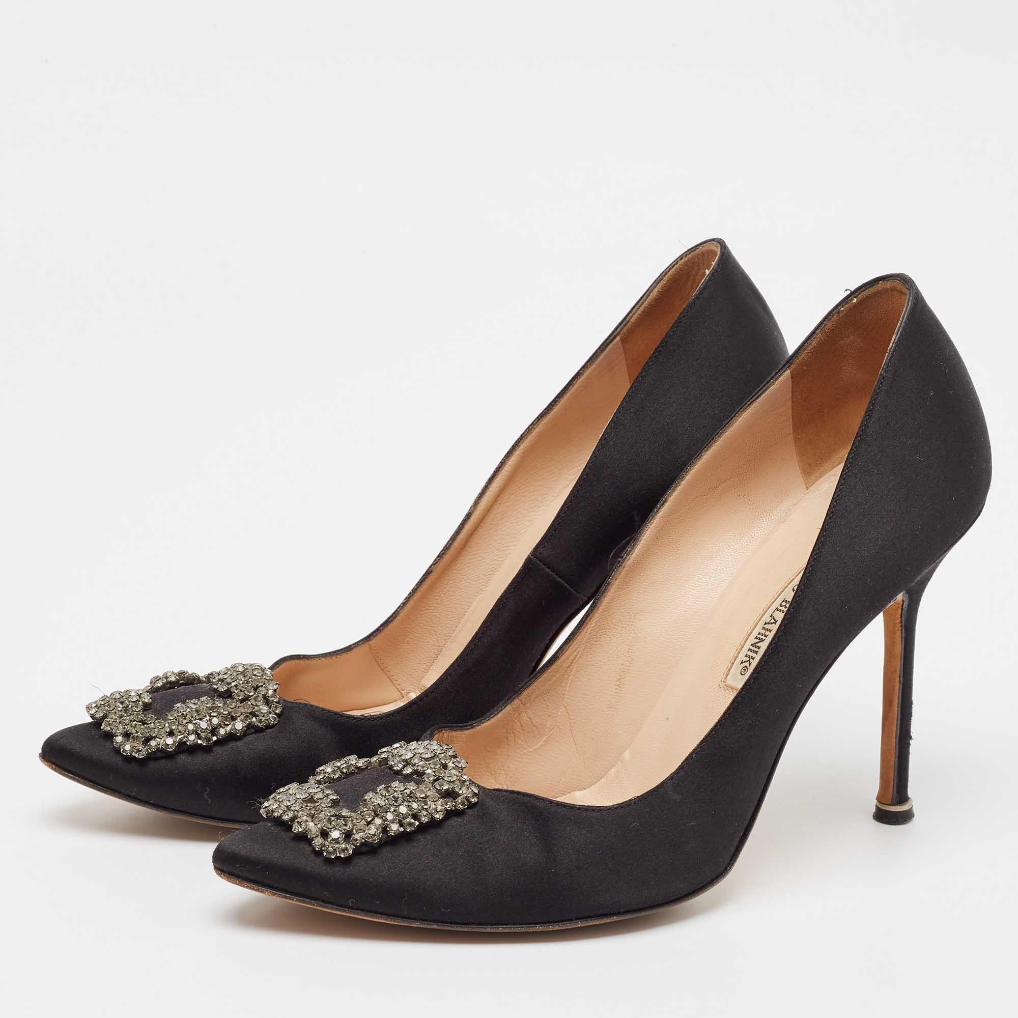 The 11.5cm heels of this pair of Manolo Blahnik pumps will reflect grace and luxury in every step. Made from satin it is made striking with a crystal embellished buckle detailing on the toes and exhibits branded insoles.