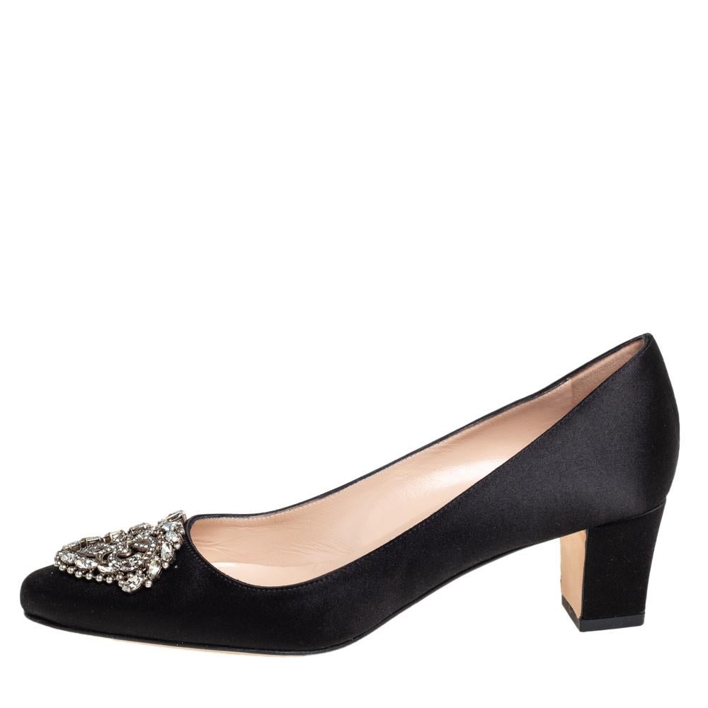 Manolo Blahnik is well-known for his graceful designs, and his label is synonymous with opulence, femininity, and elegance. These Okkato pumps are crafted from satin in a black shade into an almond toe silhouette augmented by the embellishments