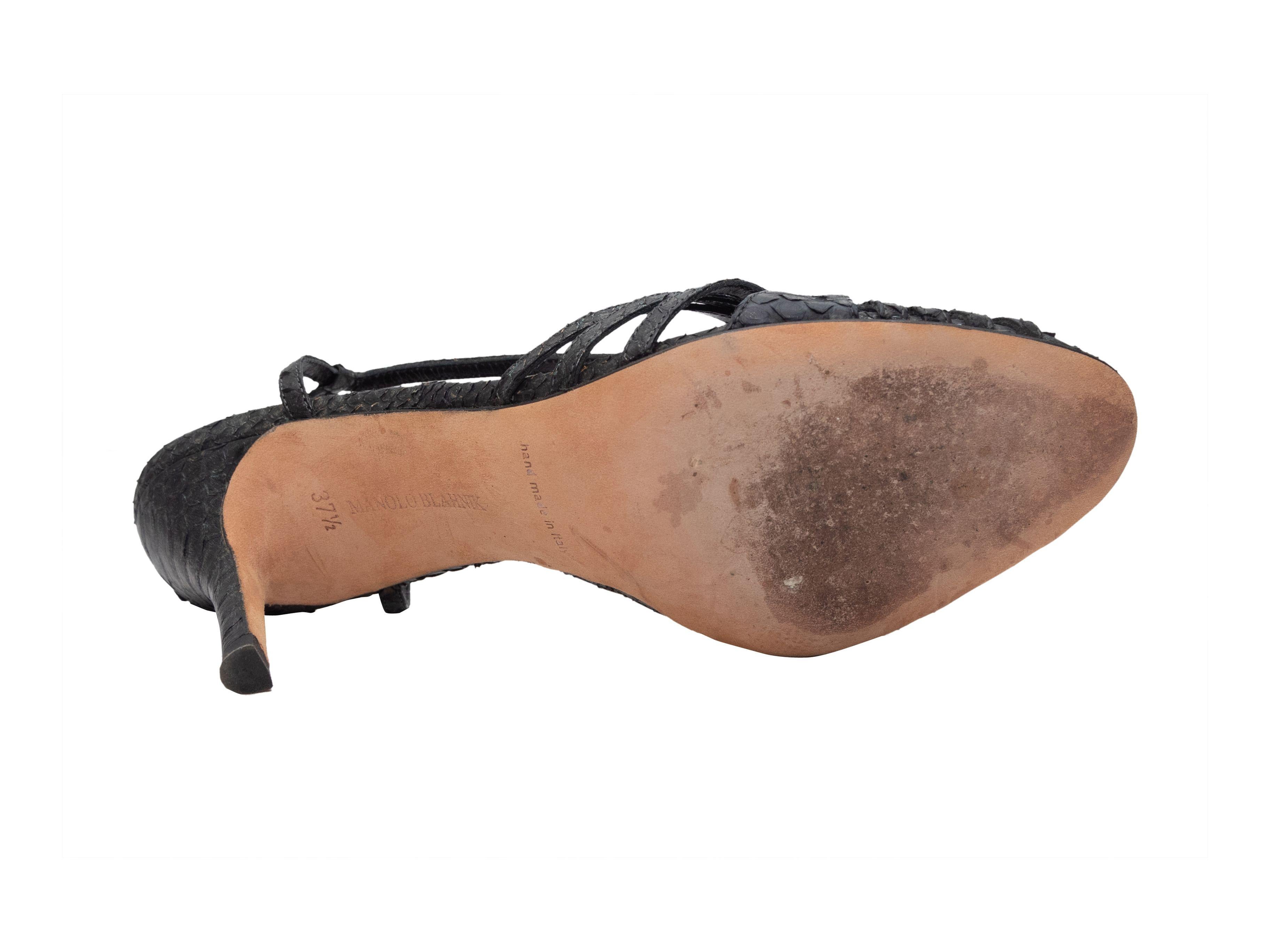 Product Details: Black snakeskin slingback sandals by Manolo Blahnik. Silver-tone buckle closures at slingback straps. 3