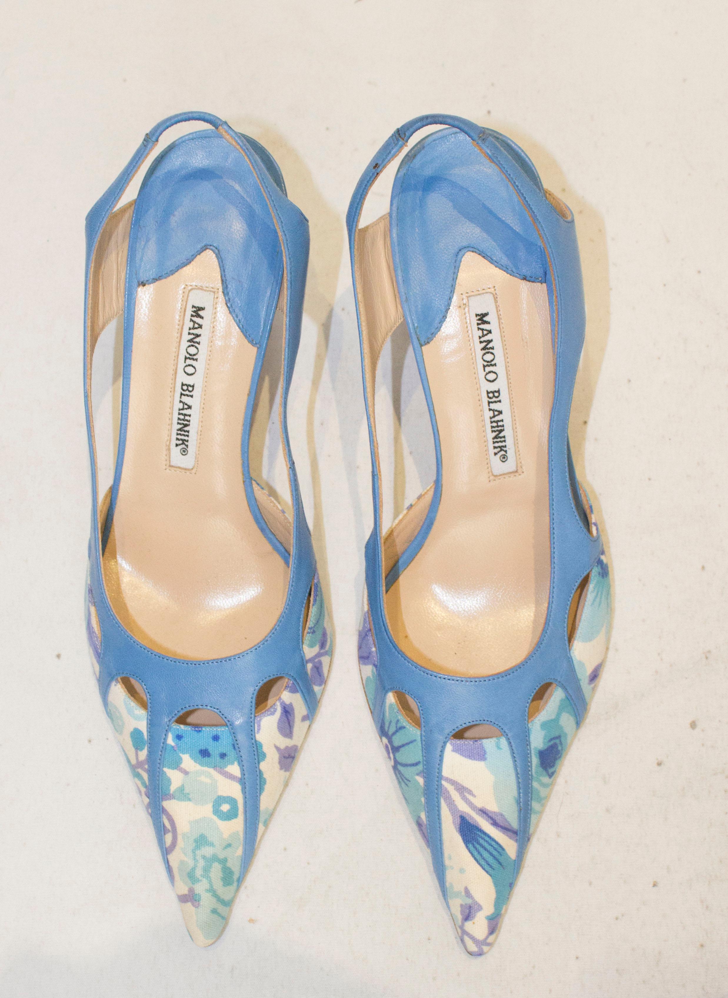 A chic pair of shoes for Summer by Manolo Blahnik. In sky blue leather and fabric , the shoes have a 3'' heel and are size 39 1/2.