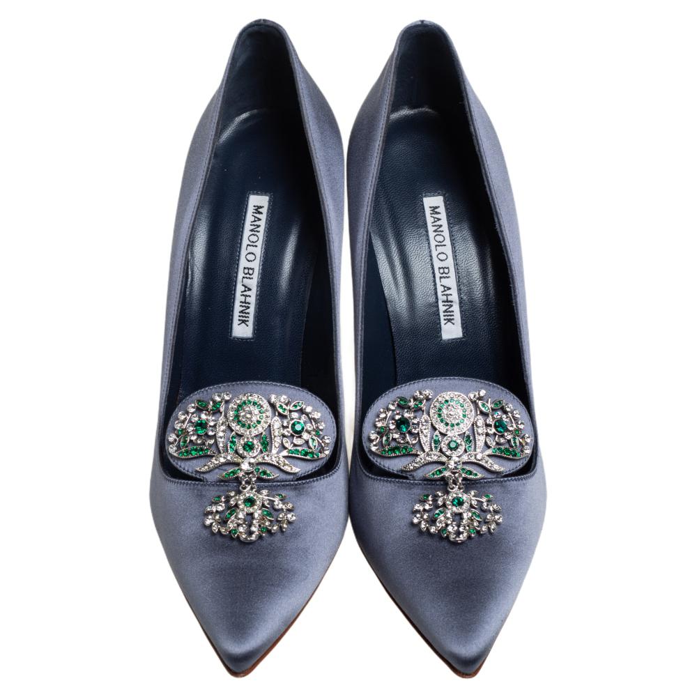 Manolo Blahnik is well-known for his graceful designs, and his label is synonymous with opulence, femininity, and elegance. These pumps are crafted from satin into a pointed toe silhouette augmented by the embellishments perched on the uppers. They