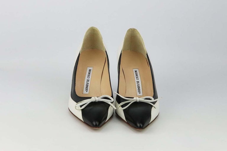 These Vintage pumps by Manolo Blahnik are a classic style that will never date, made in Italy from supple black and white leather, they have pointed toes, leather bow and comfortable 50 mm heels to take you from morning meetings to dinner with
