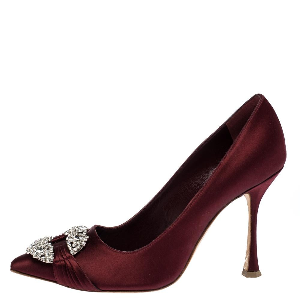 From their shape and detailing to their overall appeal, these Manolo Blahnik pumps are utterly mesmerizing. The pumps are crafted from satin and decorated with crystals on their pointed toe box. They are complete with comfortable leather-lined