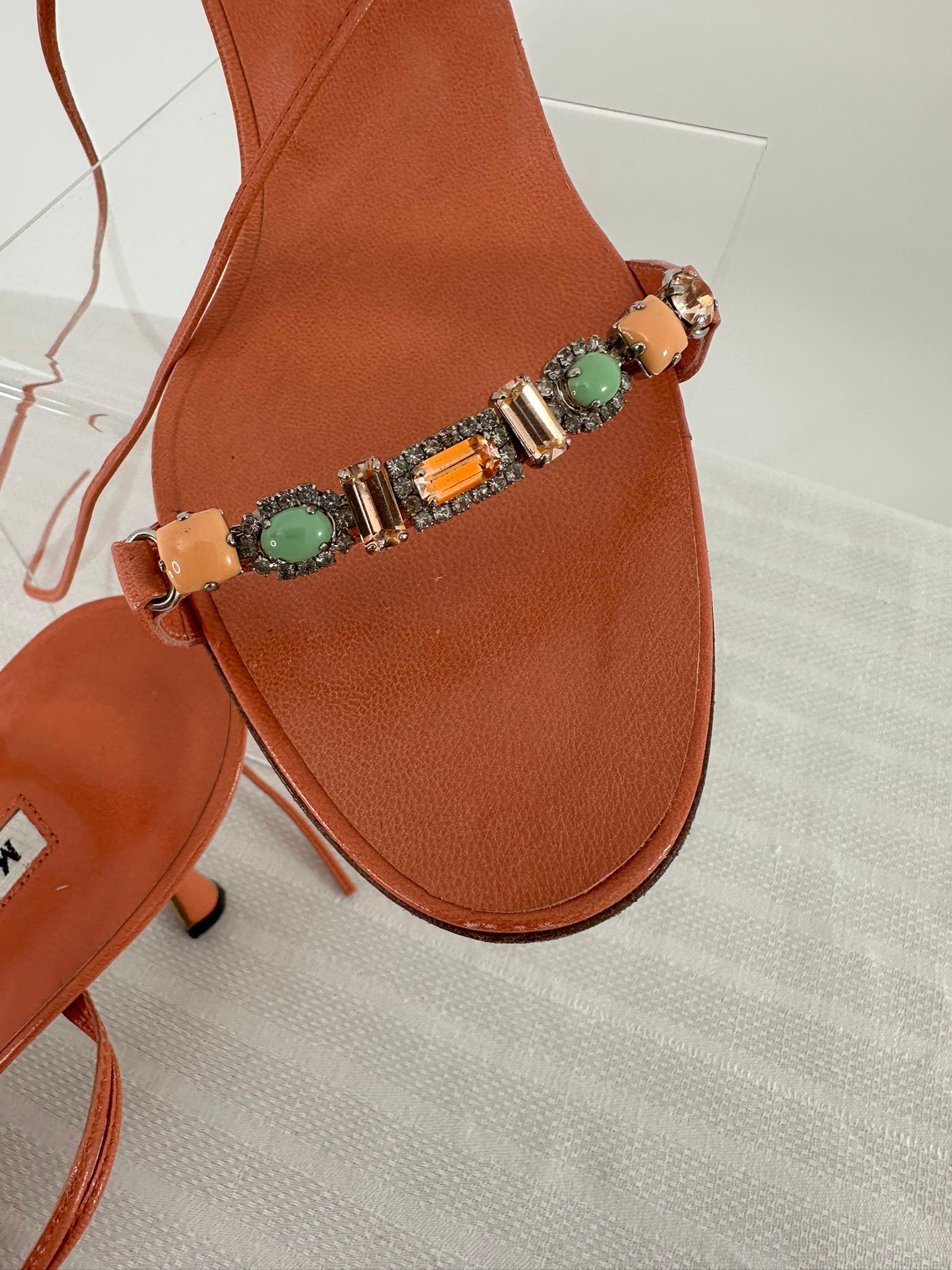 Manolo Blahnik coral leather ankle wrap high heel sandals with coral, turquoise, crystal rhinestone & leather toe bar strap at each shoe front. Natural leather soles. These beautiful shoes are marked size 39. In very good pre-owned condition, look