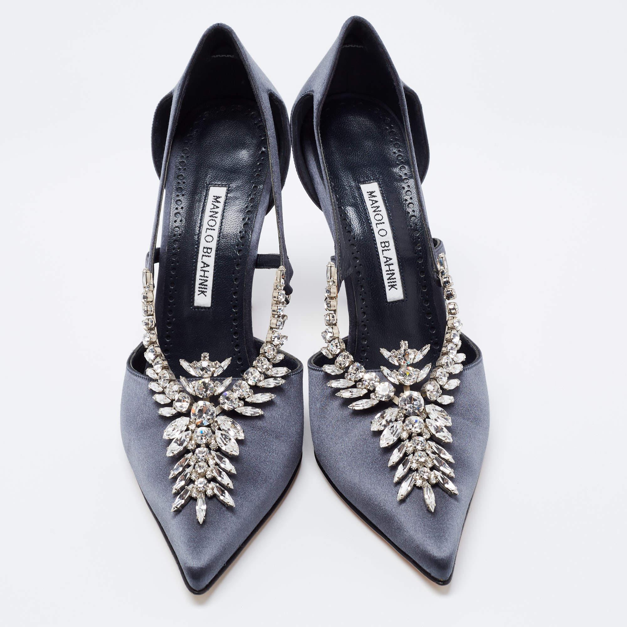 To lend your feet elegance, Manolo Blahnik brings you these gorgeous pumps. From their sleek shape and luscious dark grey finish to their overall appeal, they are utterly mesmerizing. The pumps come crafted from smooth satin and are designed with