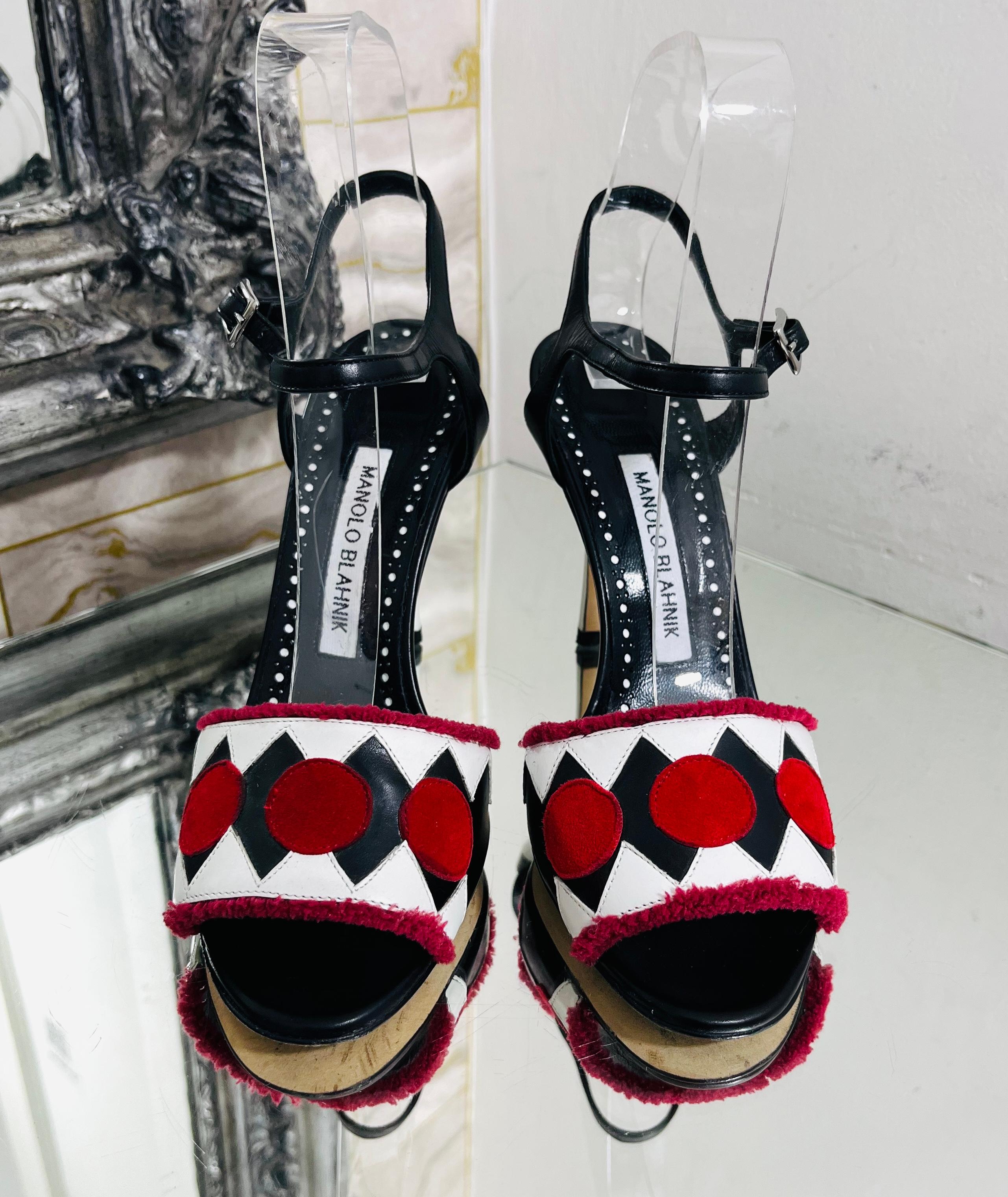 Manolo Blahnik Geometric Print Leather Sandals

Black , slingback heels styled with raw-trimmed strap designed with geometric black and white pattern and red, suede circles.

Featuring leather, buckled ankle strap and white heel.

Size –