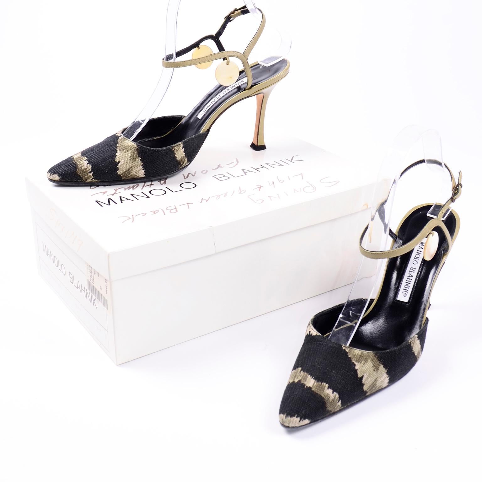 These are really fun vintage Manolo Blahnik black and green canvas printed pointed toe slingback shoes. These shoes have beautiful green leather heels with cream/sage circle discs dangling along the sides of the ankles. There is a metal loop