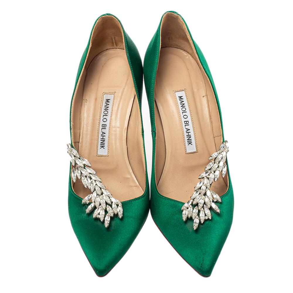 Manolo Blahnik is well-known for his graceful designs, and his label is synonymous with opulence, femininity, and elegance. These Nadira pumps are crafted from satin in a green hue into a pointed toe silhouette augmented by dazzling crystal
